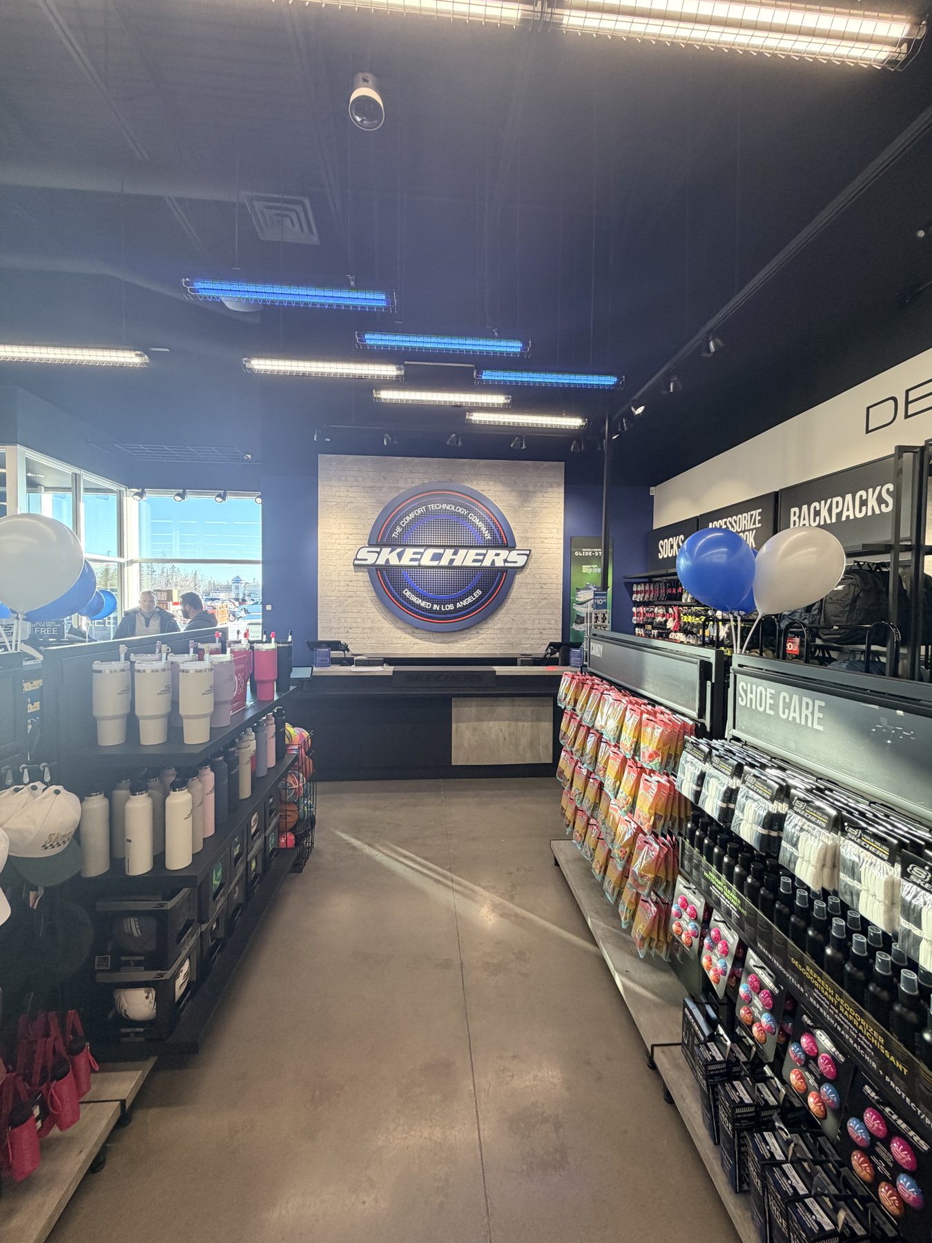 Newly stocked shoe store with retail displays and brand signage — Skechers (Signal Hill)