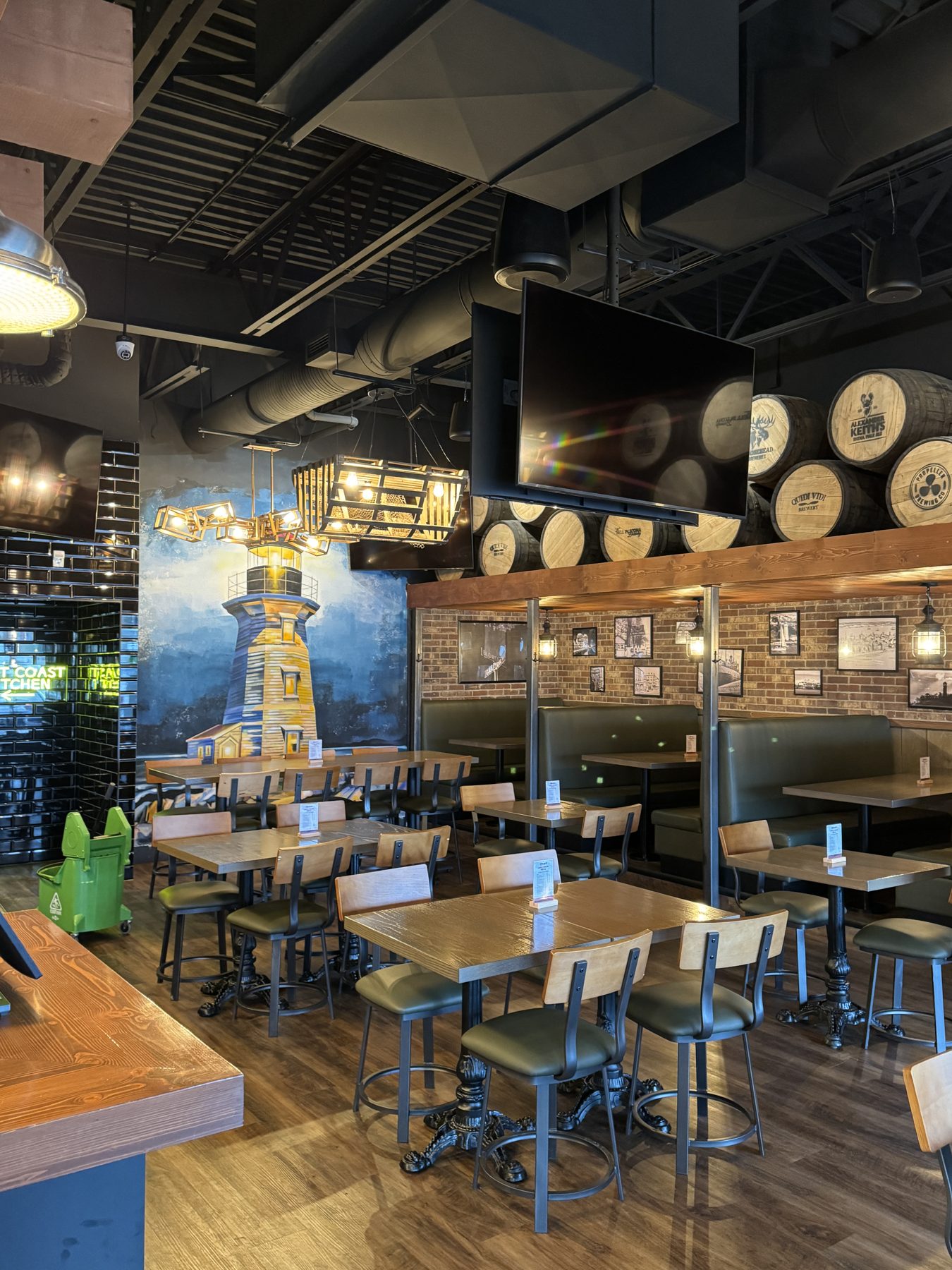 Restaurant interior with lighthouse mural, barrel decor, and booth seating — Blowers and Grafton (Lloydminster)
