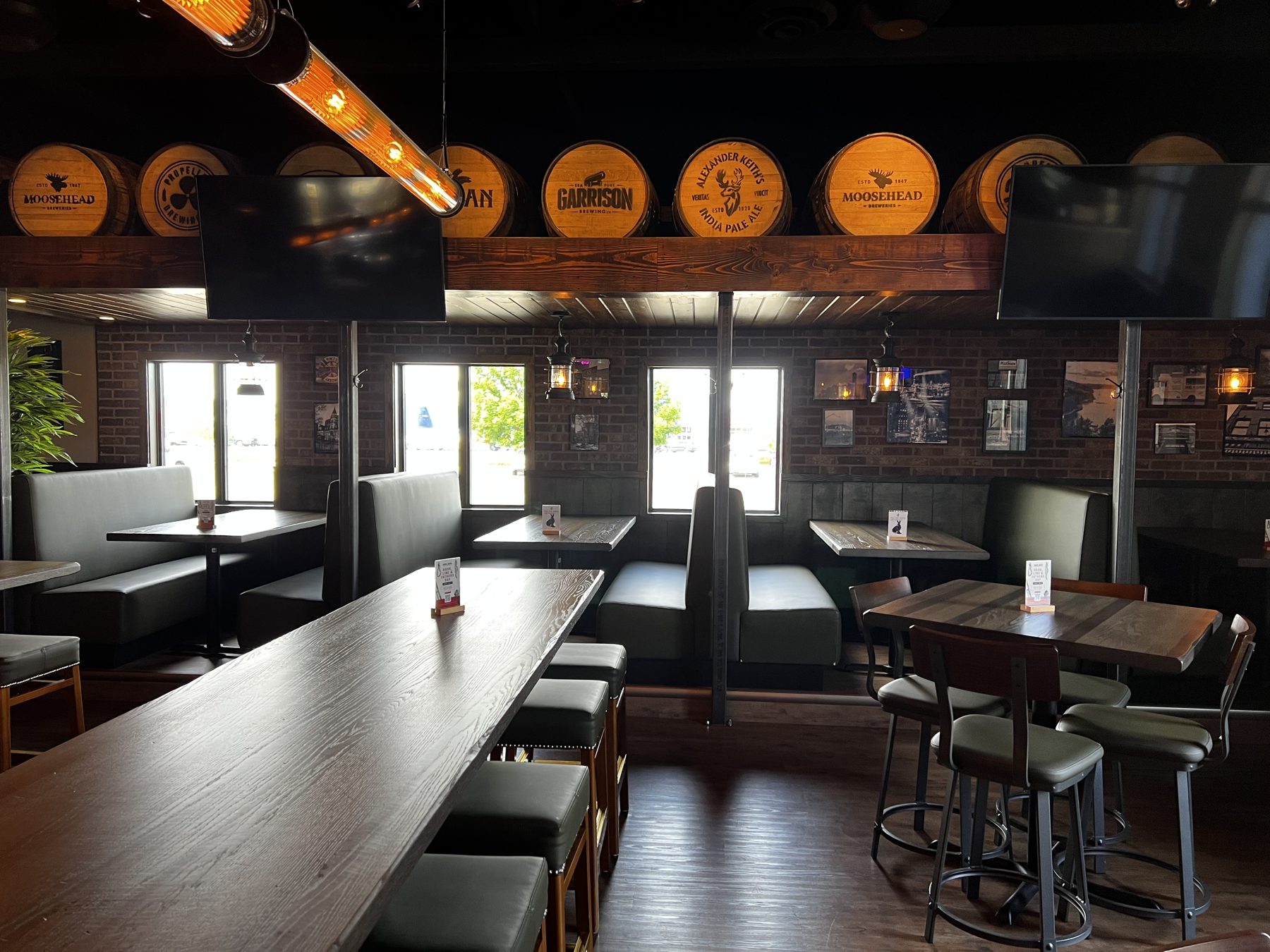 Restaurant interior with wood tables, booths, and barrels for decor — Blowers and Grafton (Shawnessy)