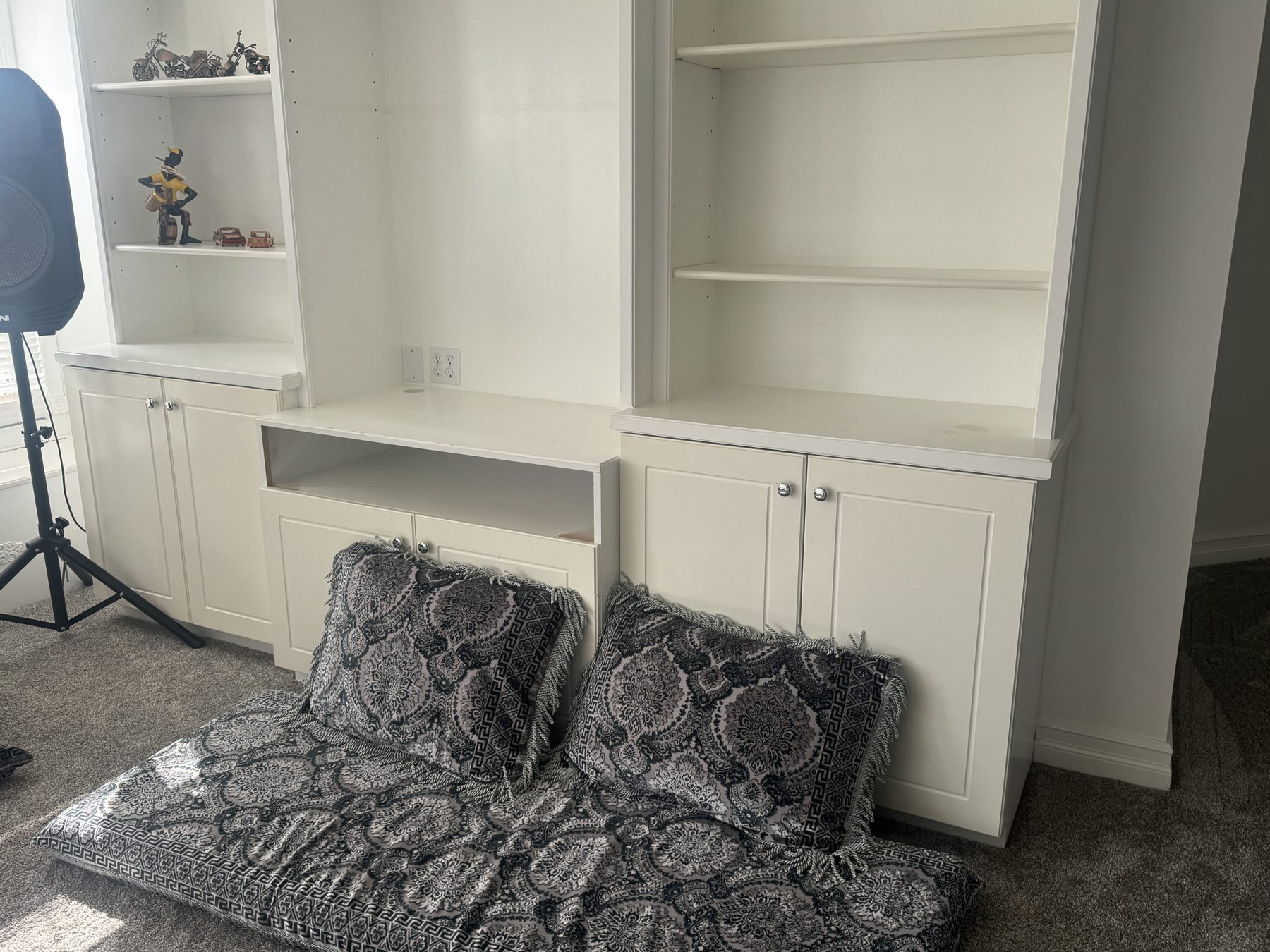 Newly installed white built-in cabinets with open shelving and decorative items — 14 Lochend Drive, Cochrane