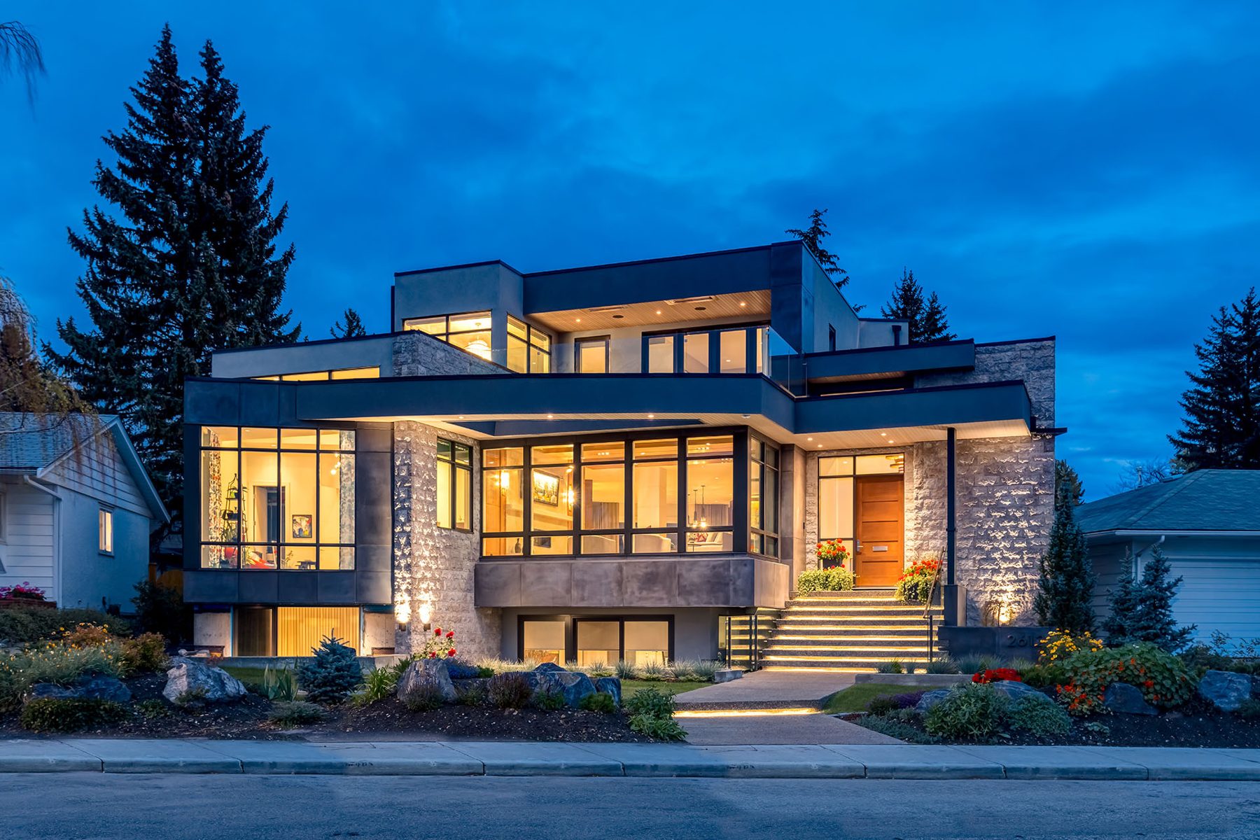 Modern home exterior with stone, glass, and wood accents — Evolution by Onsite Contracting Services