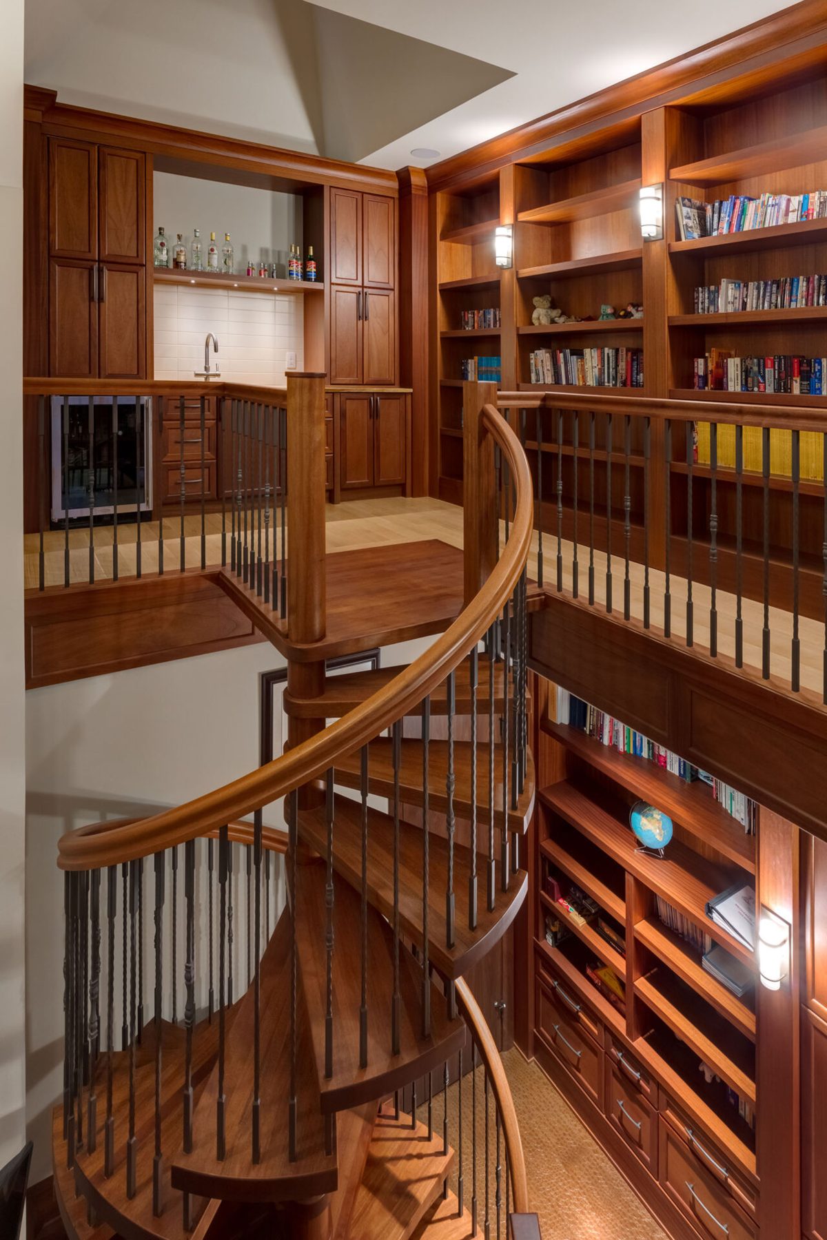 Spiral staircase, built-in bar, and bookshelves in a newly finished room — Oxford