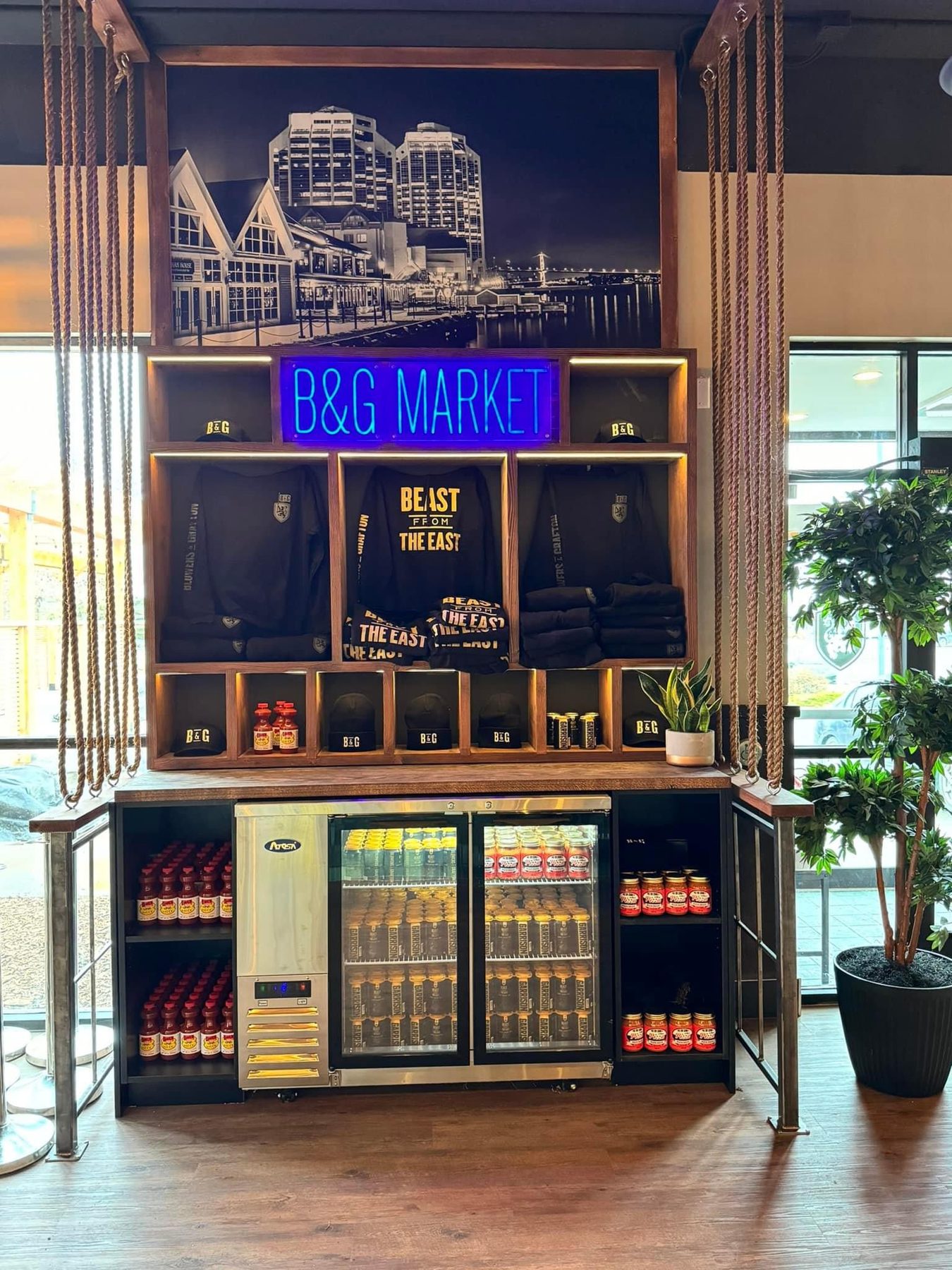 Retail display with neon sign, apparel, drinks, and sauces — Blowers and Grafton (Shawnessy)