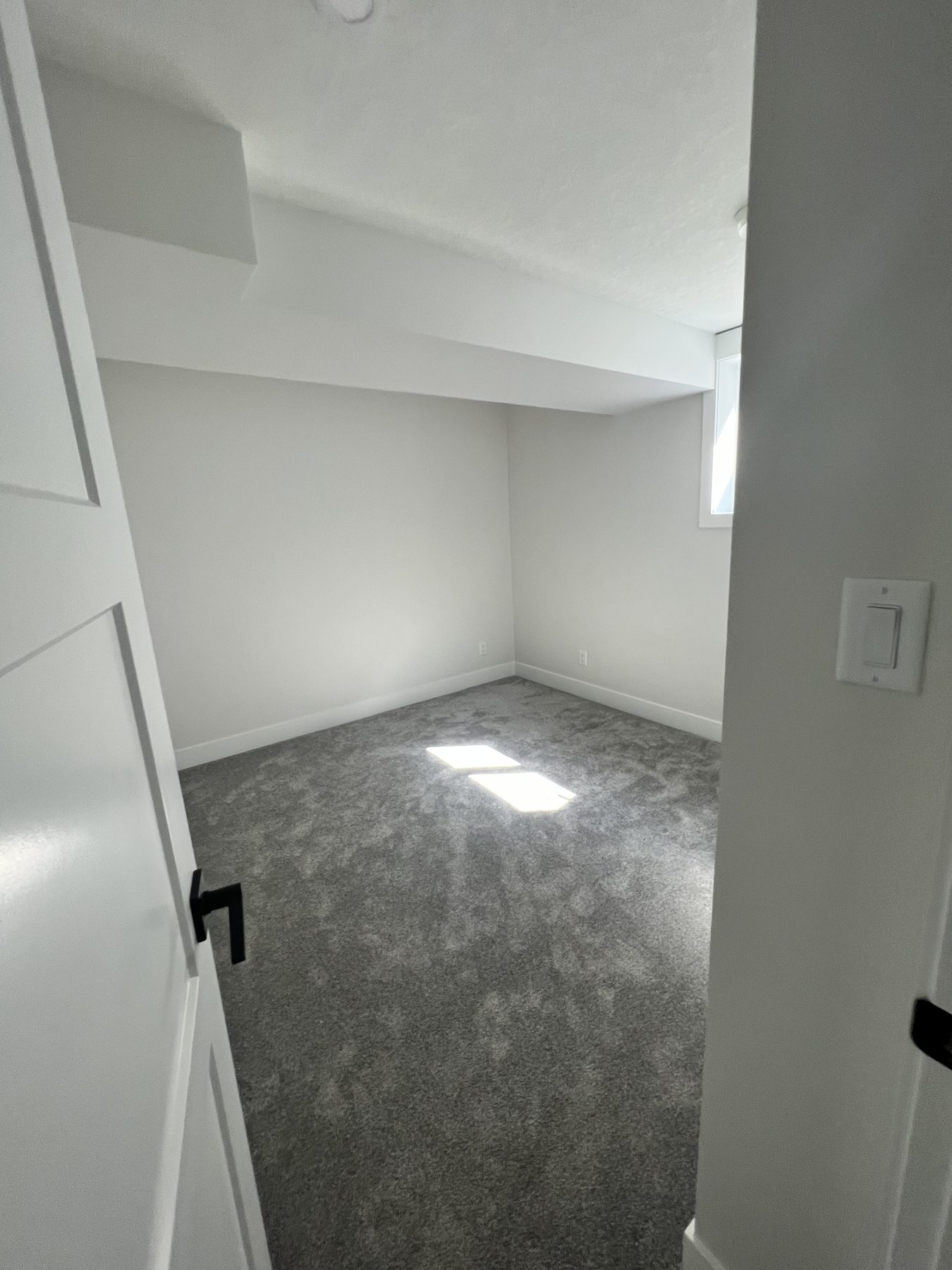 Newly carpeted room with white walls, door, and trim — 720 Lake Twintree Crescent SE, Calgary