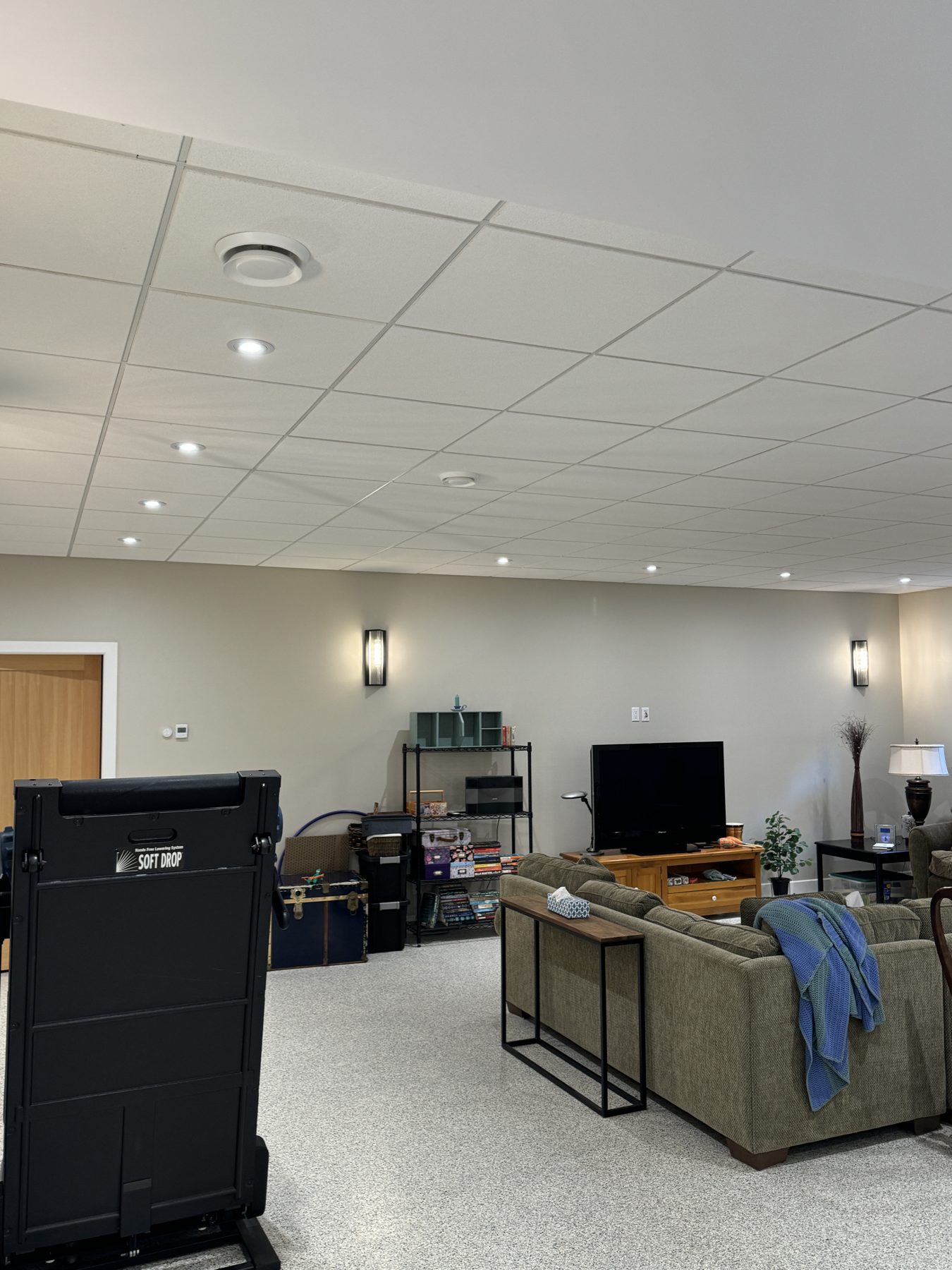 Basement renovation with suspended ceiling, recessed lights, and furniture staged — 18 Varsplain Place Northwest