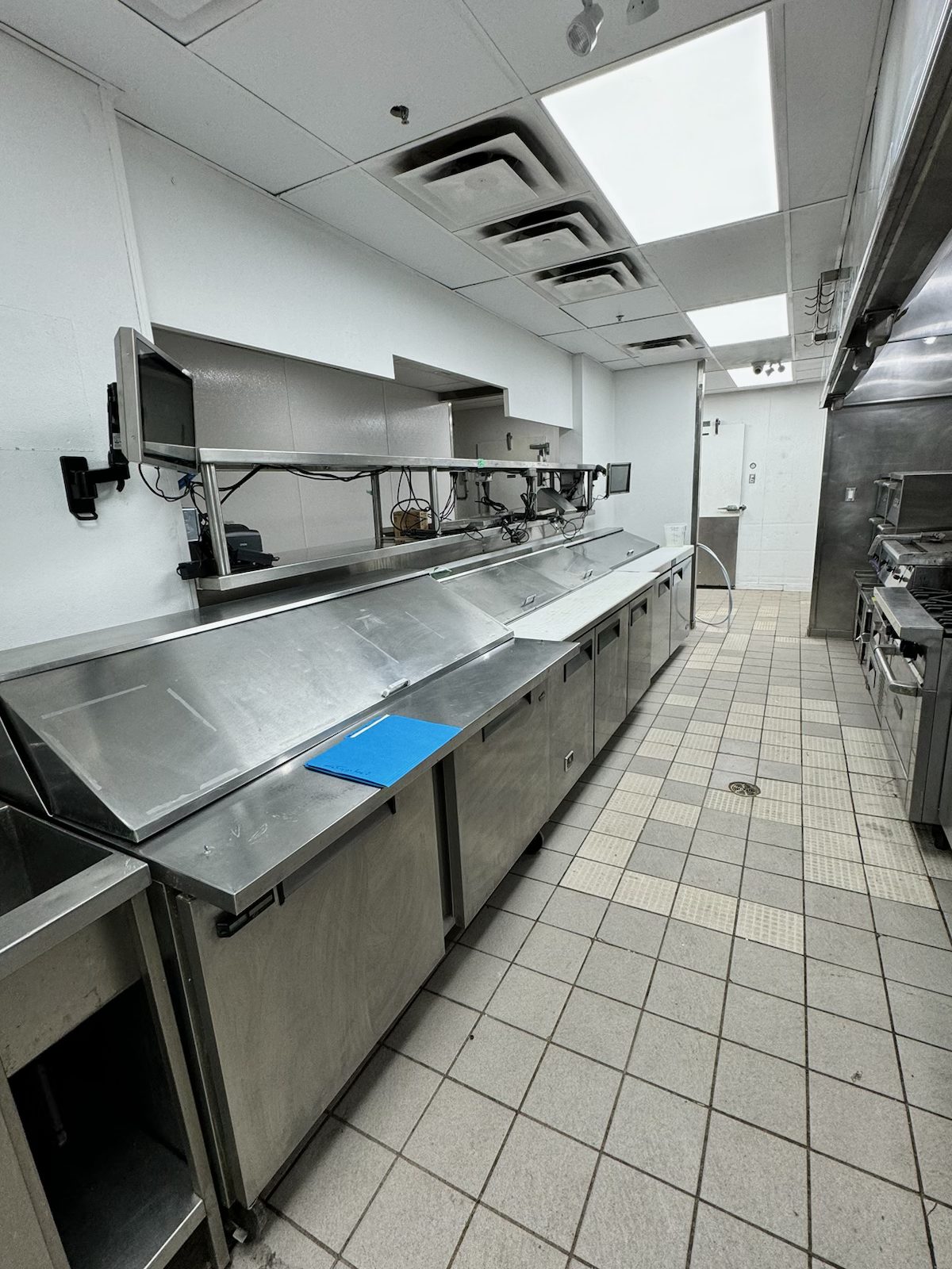 Commercial kitchen with stainless steel counters and tiled floor — Blowers and Grafton (Medicine Hat)