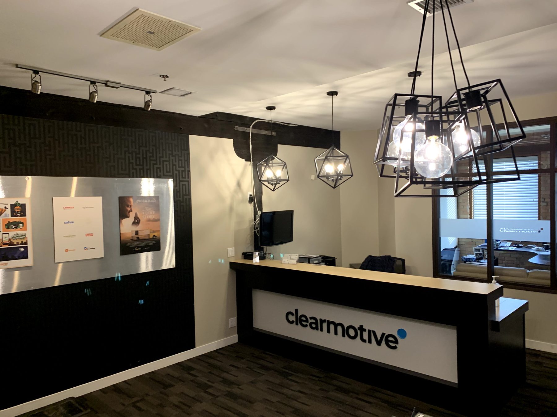 Modern reception desk with geometric light fixtures and artwork — Clearmotive (Victoria Park)