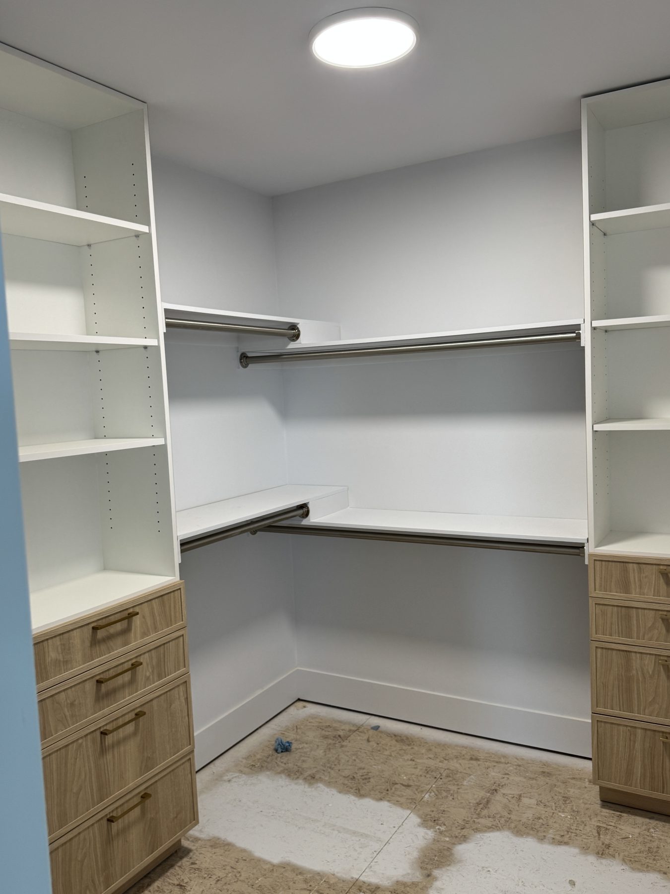 Walk-in closet with white shelving, wood drawers, and metal rods — 14 Lochend Drive, Cochrane