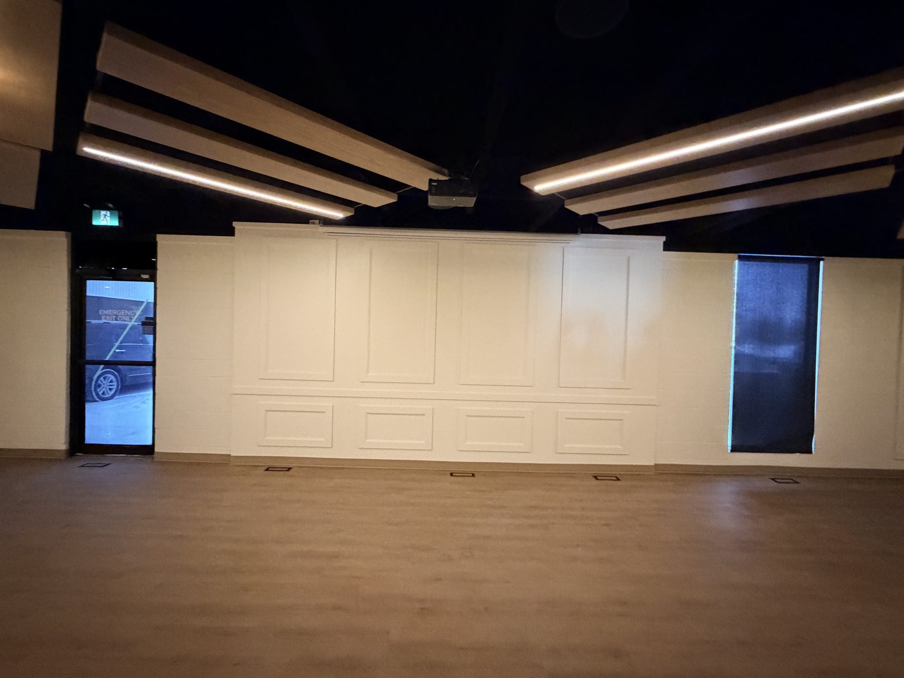 Modern room renovation with wood panel ceiling and wainscoted walls — The Barron Venue