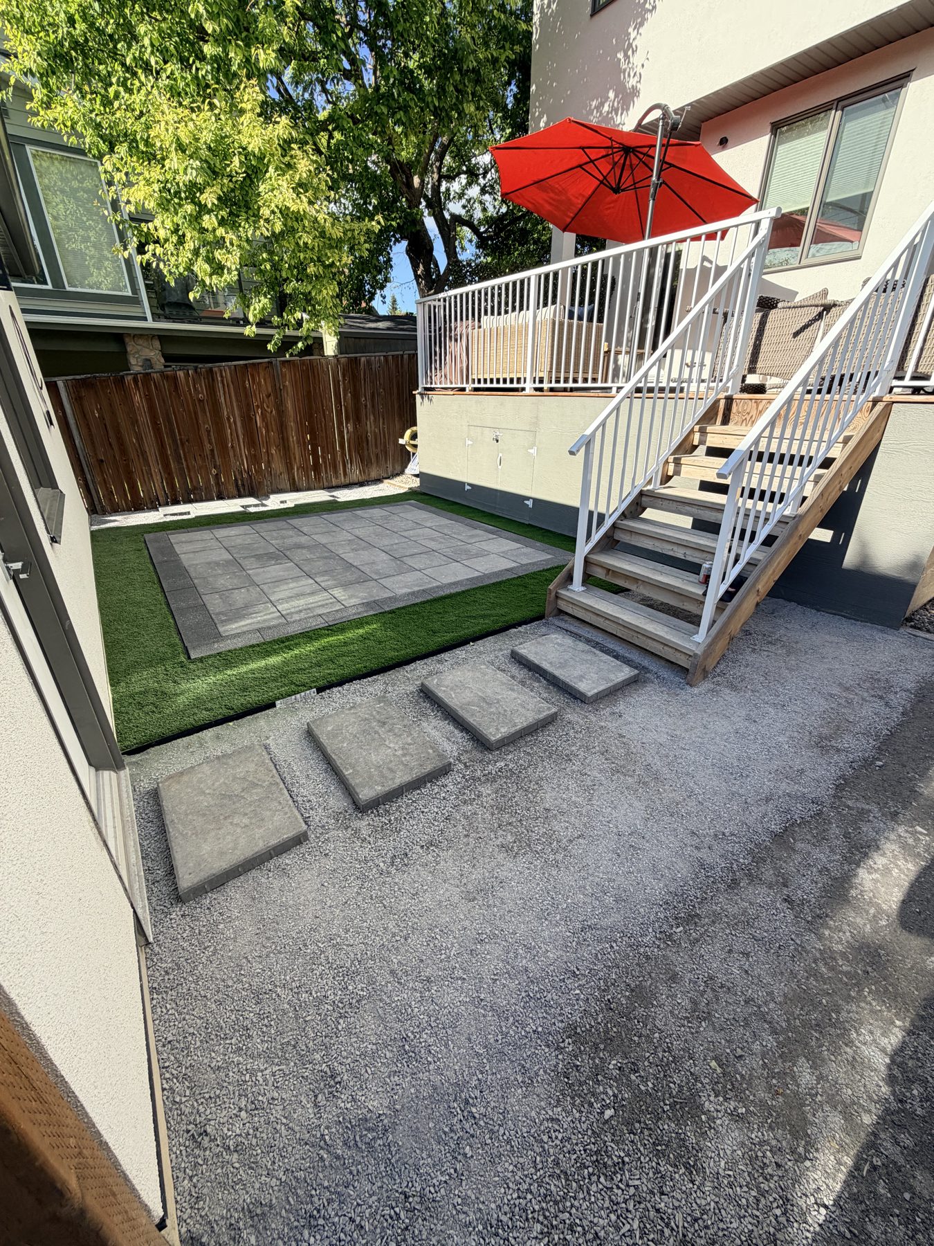 Newly laid patio tiles, turf, and stepping stones with outdoor stairs — 3505 41 Street SW, Calgary