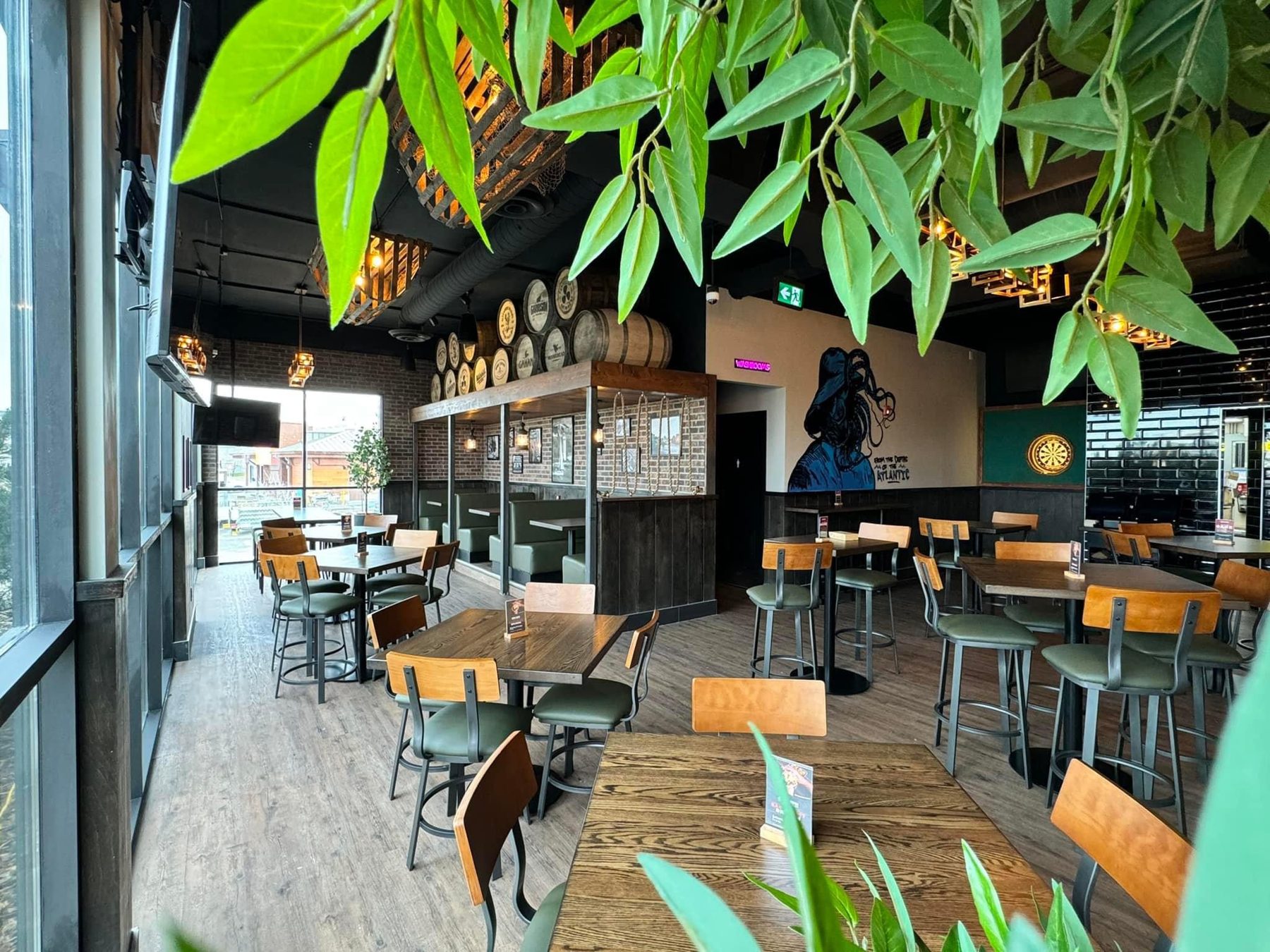 Restaurant interior with dark wood tables, green chairs, and brick accents — Blowers and Grafton (Shawnessy)