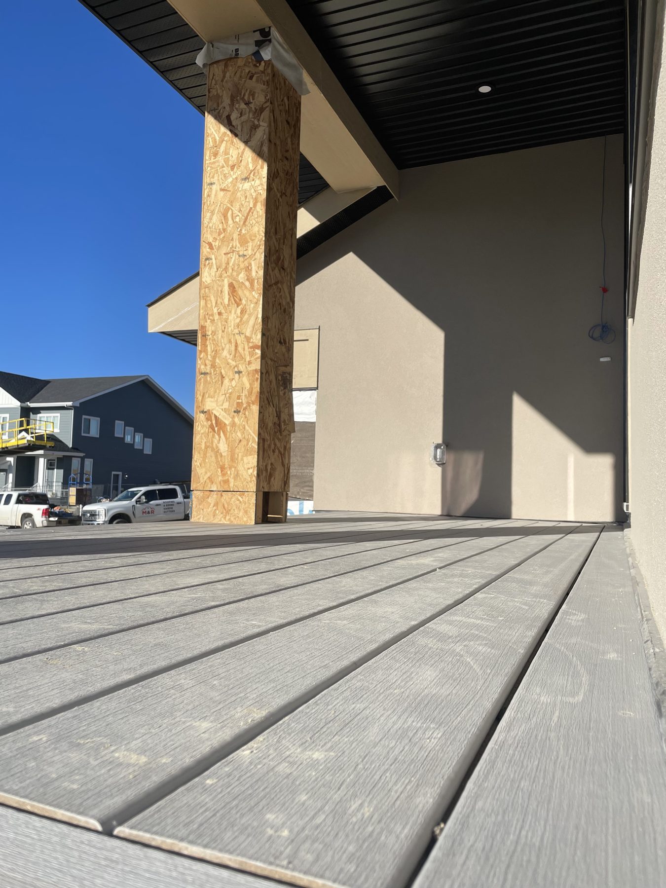 Under construction deck with covered patio and wood support post — 96 Fieldstone Close