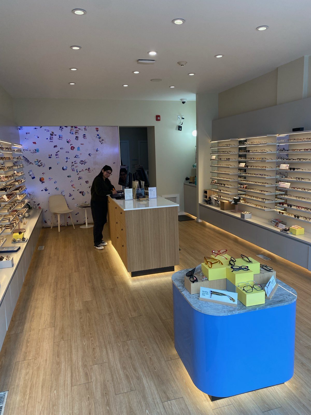 Eyeglass store with display shelves, wooden counter, and lighting — 104 10 Street Northwest, Calgary (Bailey Nelson) by Onsite Contracting Services