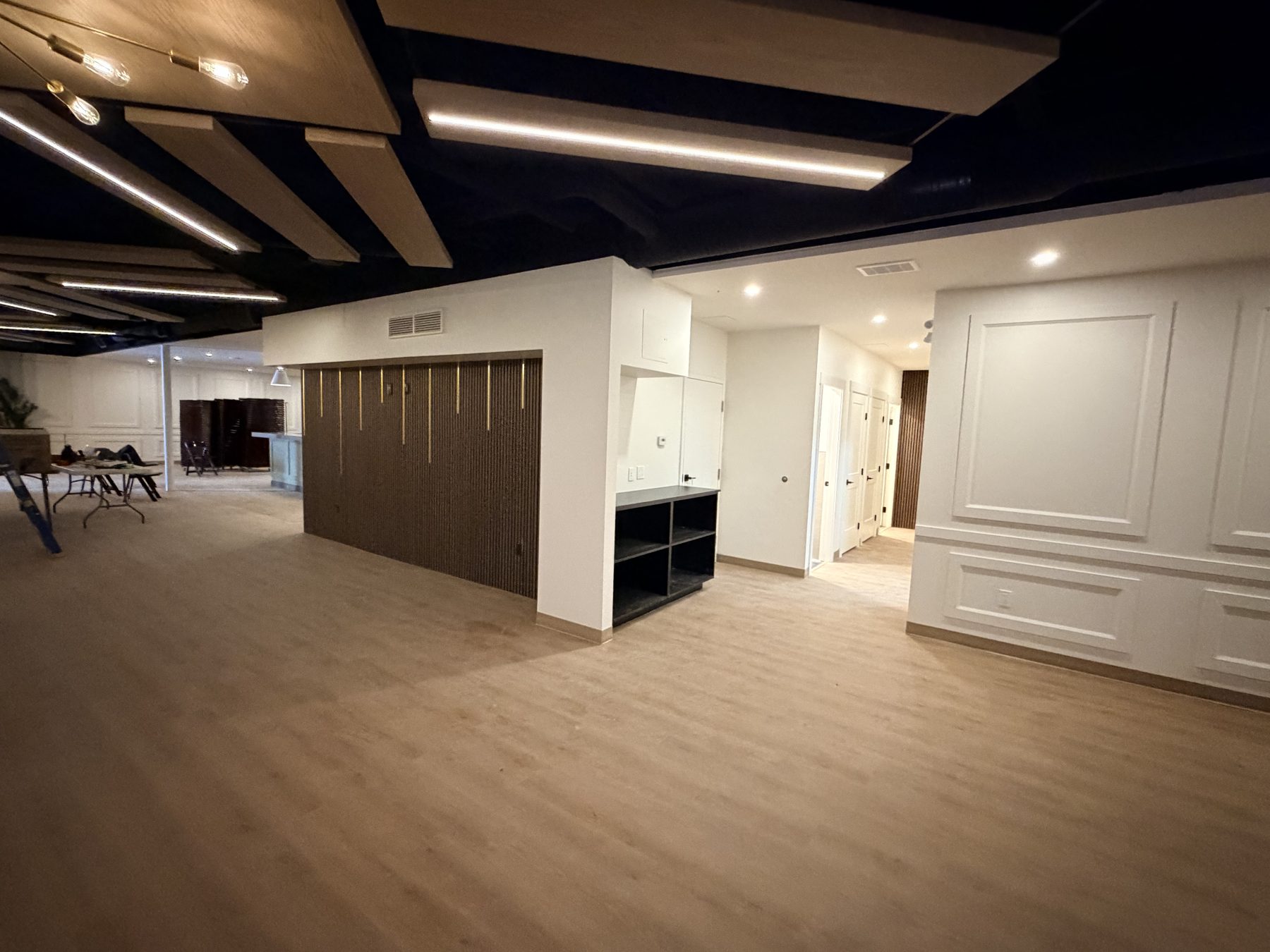 Modern interior renovation with wood paneling, recessed lighting, and new flooring — The Barron Venue