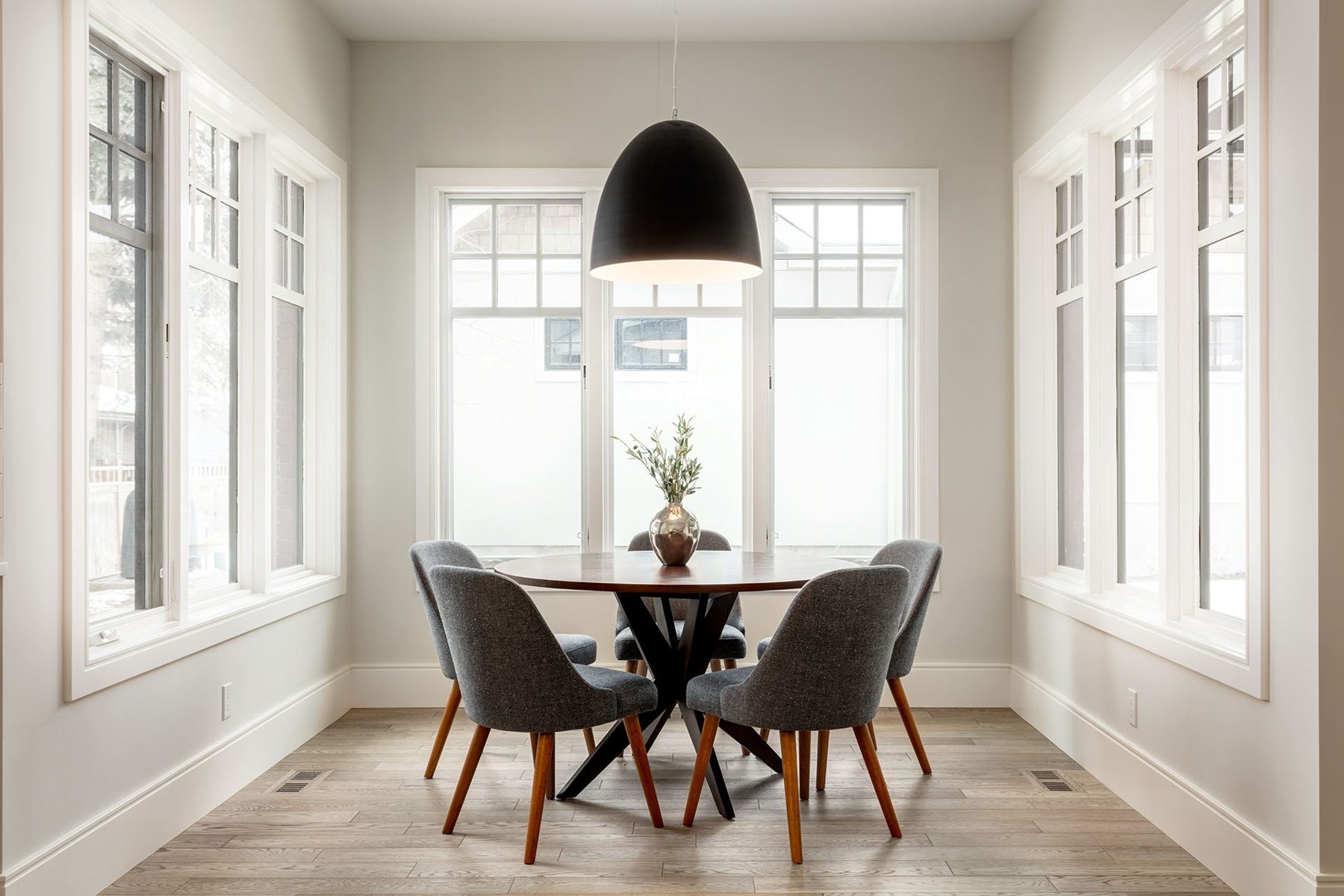 Completed dining room with round table, four chairs, and large windows — Cleret Velour
