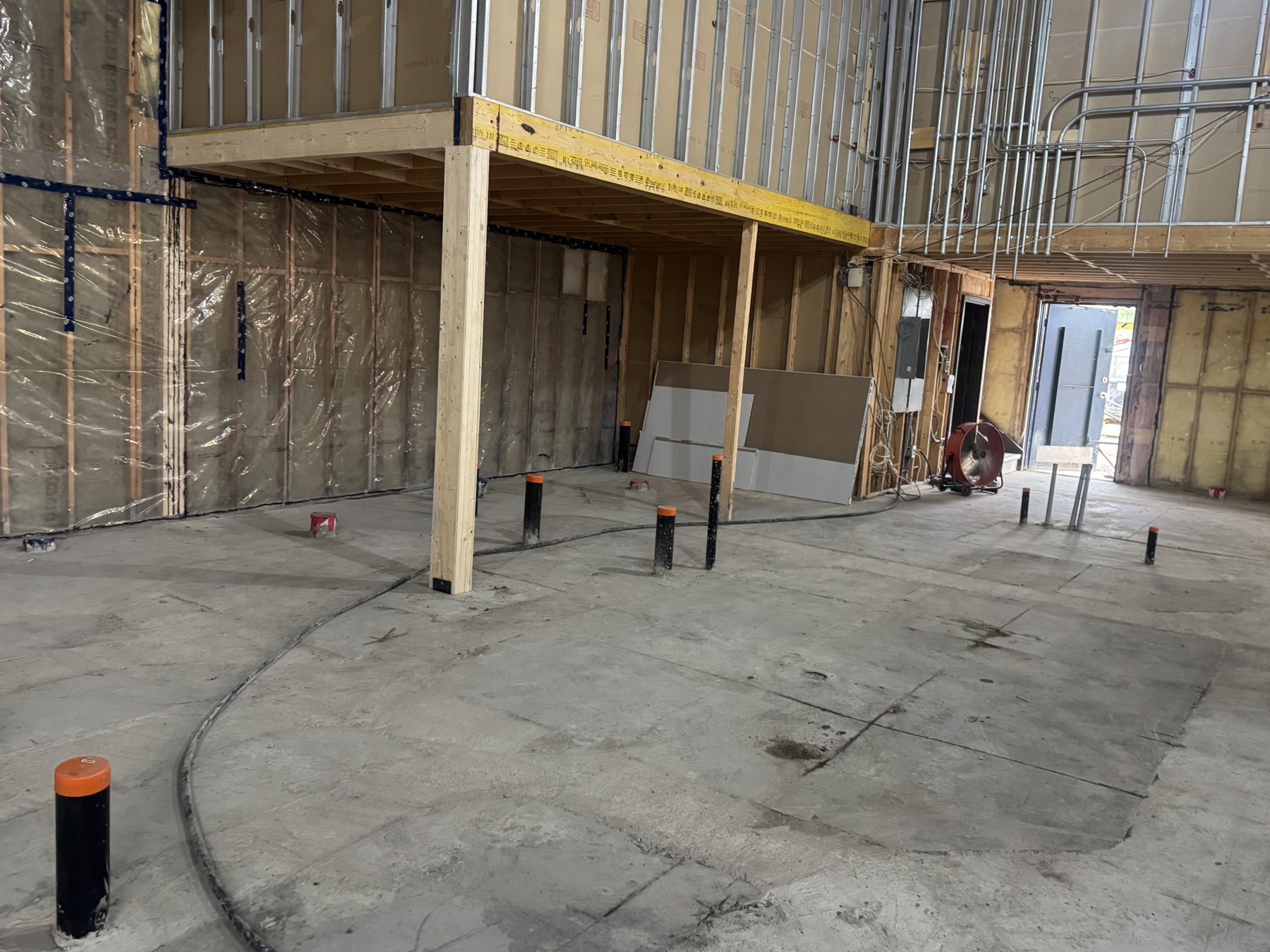 Interior construction with exposed framing, insulation, and plumbing rough-ins — Blowers and Grafton (Red Deer)