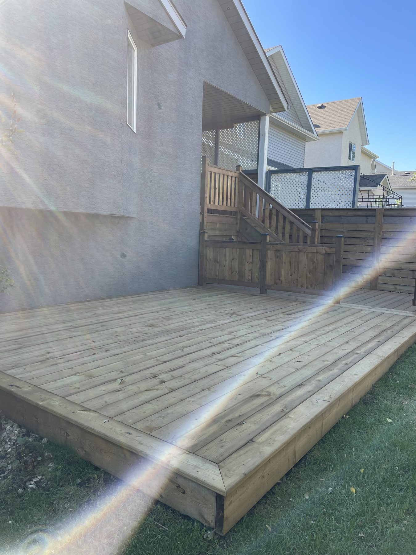 New wooden deck and stairs with railing, partially completed — 32 Somercrest Manor SW
