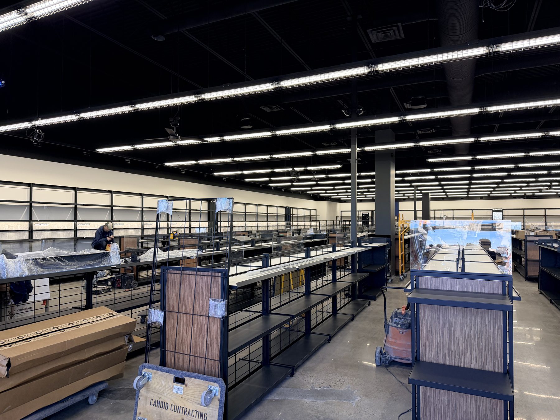 Retail store under construction with shelving units and lighting — Skechers (Signal Hill)