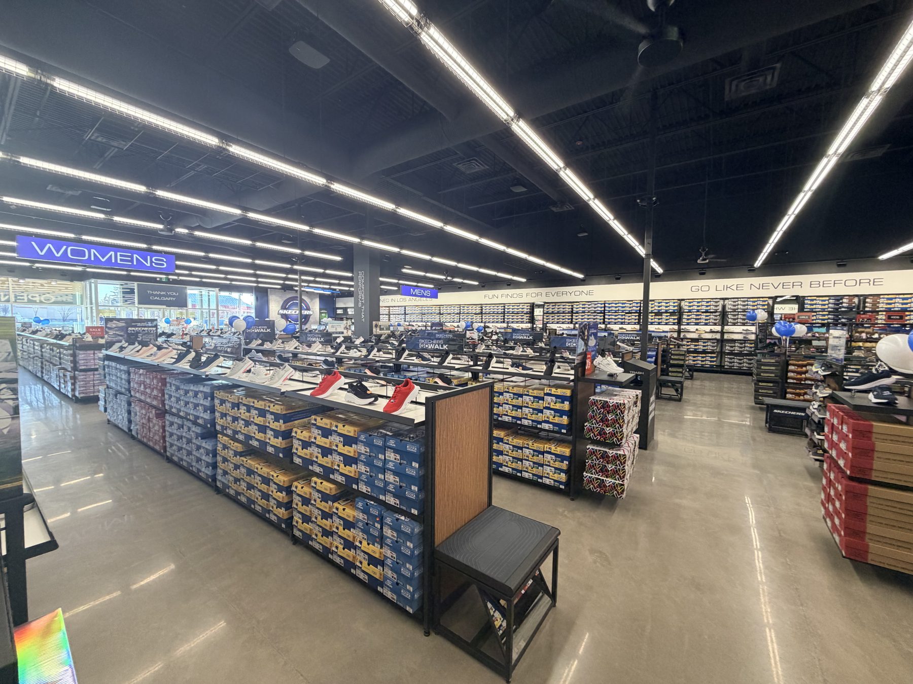 Shoe store interior with display shelves filled with boxes and shoes — Skechers (Signal Hill)