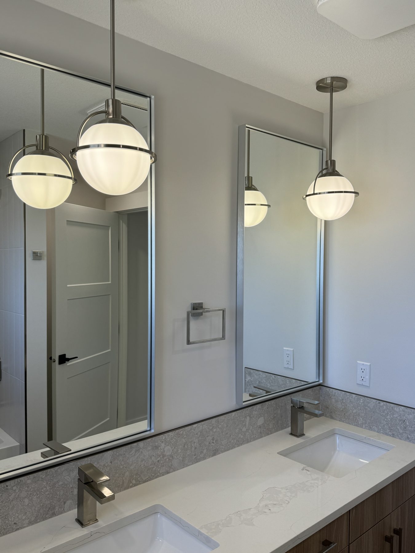 Modern bathroom vanity with globe pendant lights and quartz countertop — Lake Bonavista