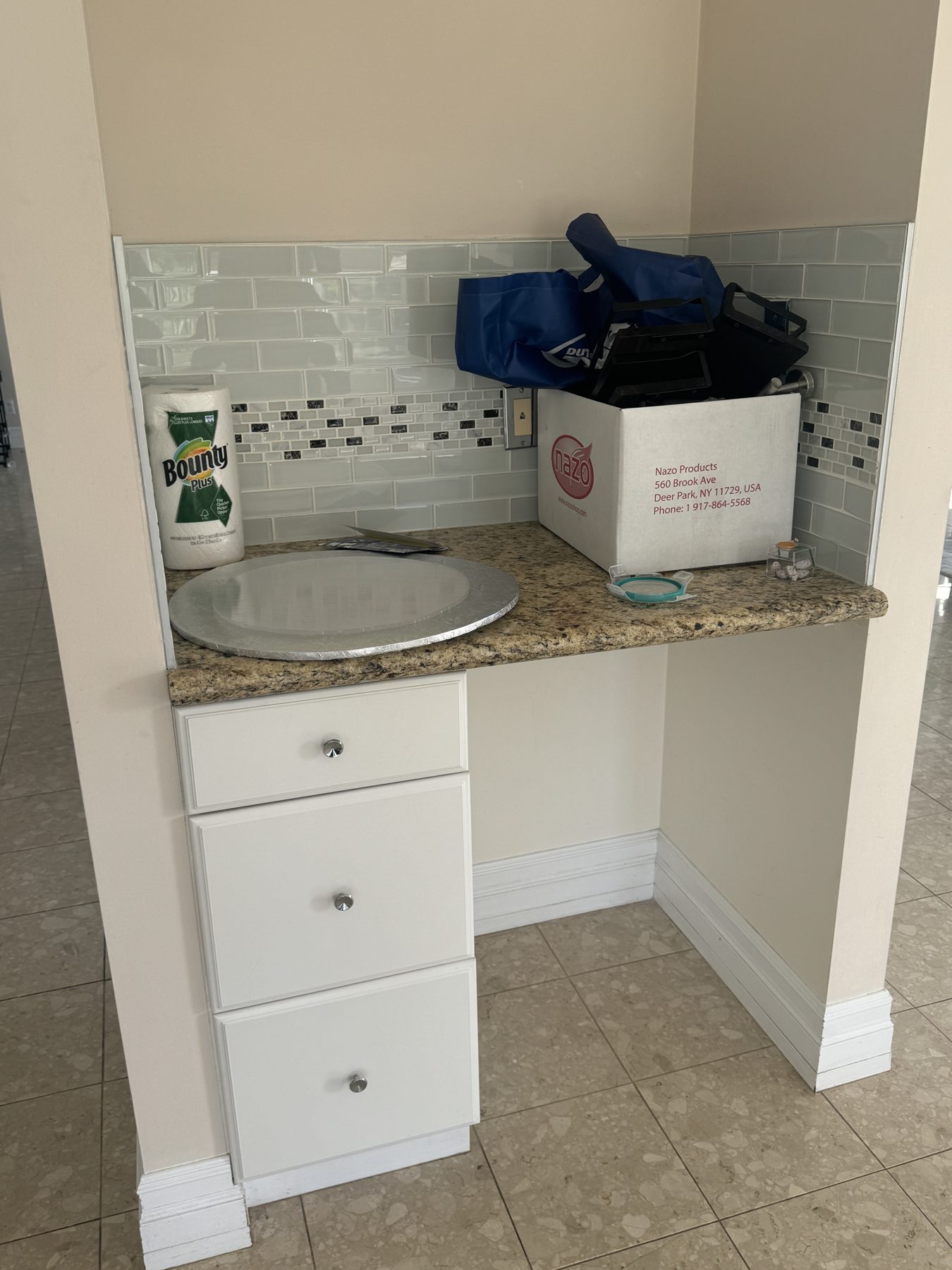 Newly tiled backsplash and granite countertop with white drawers installed — 14 Lochend Drive, Cochrane