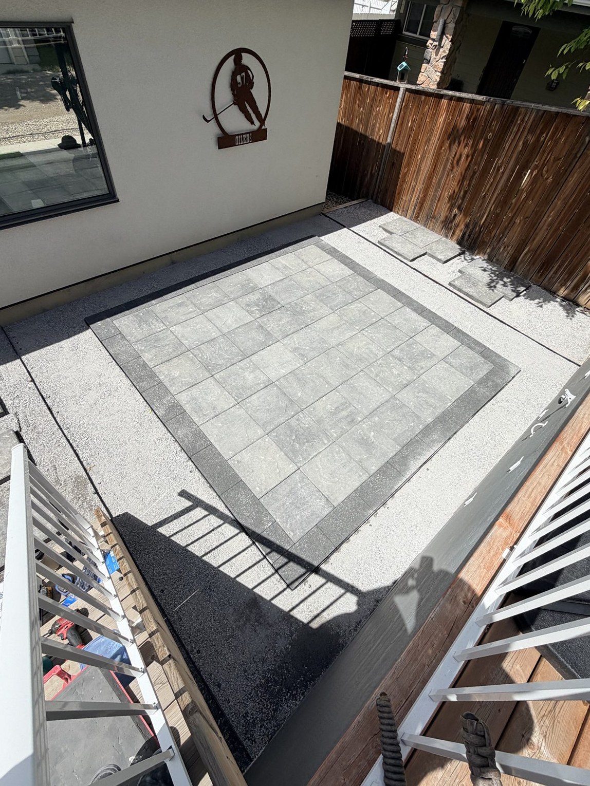 Outdoor patio with grey pavers and gravel, in progress — 3505 41 Street SW, Calgary