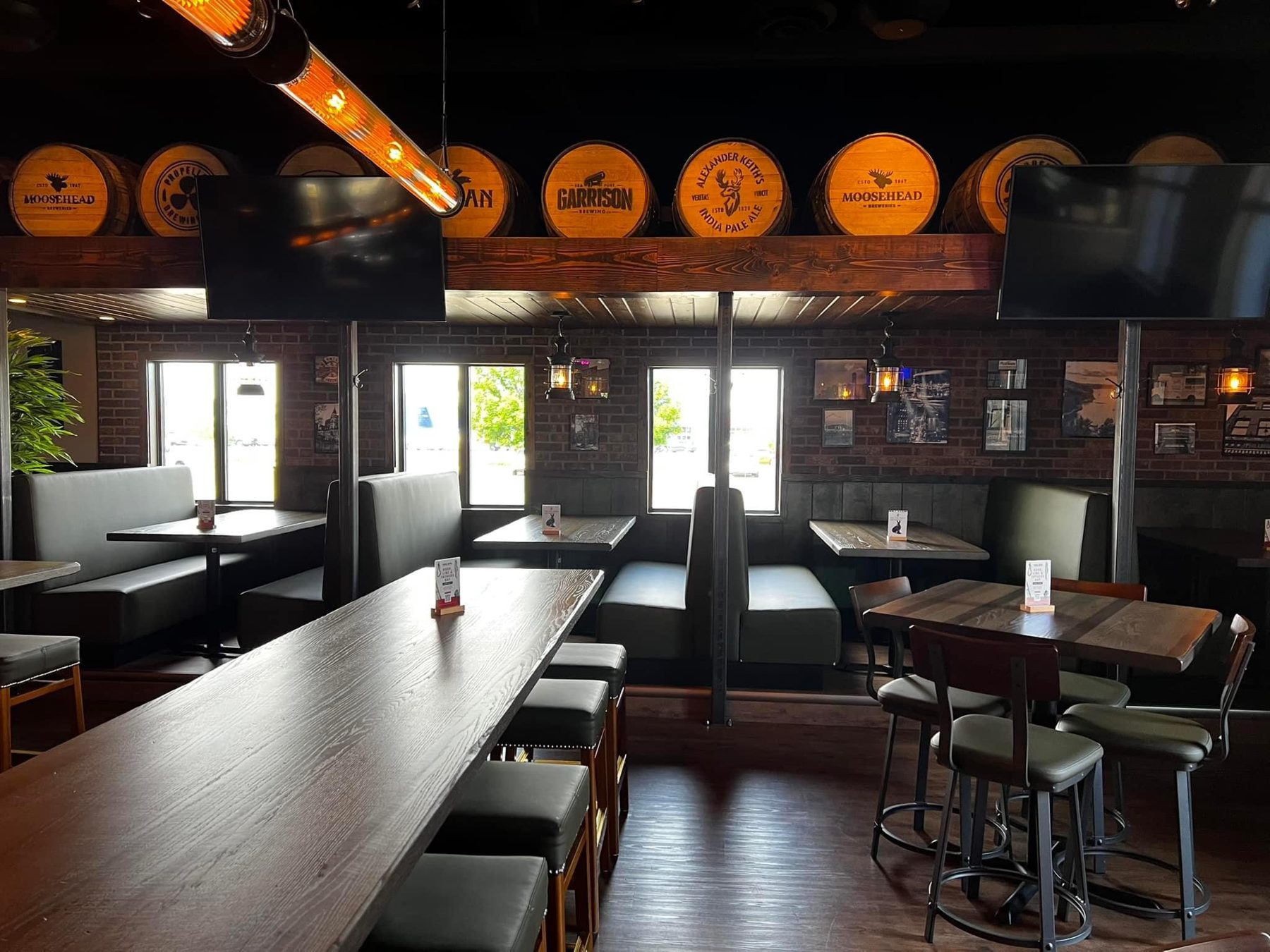 Restaurant interior with wooden barrels, booth seating, and brick walls — Blowers and Grafton (Lethbridge)
