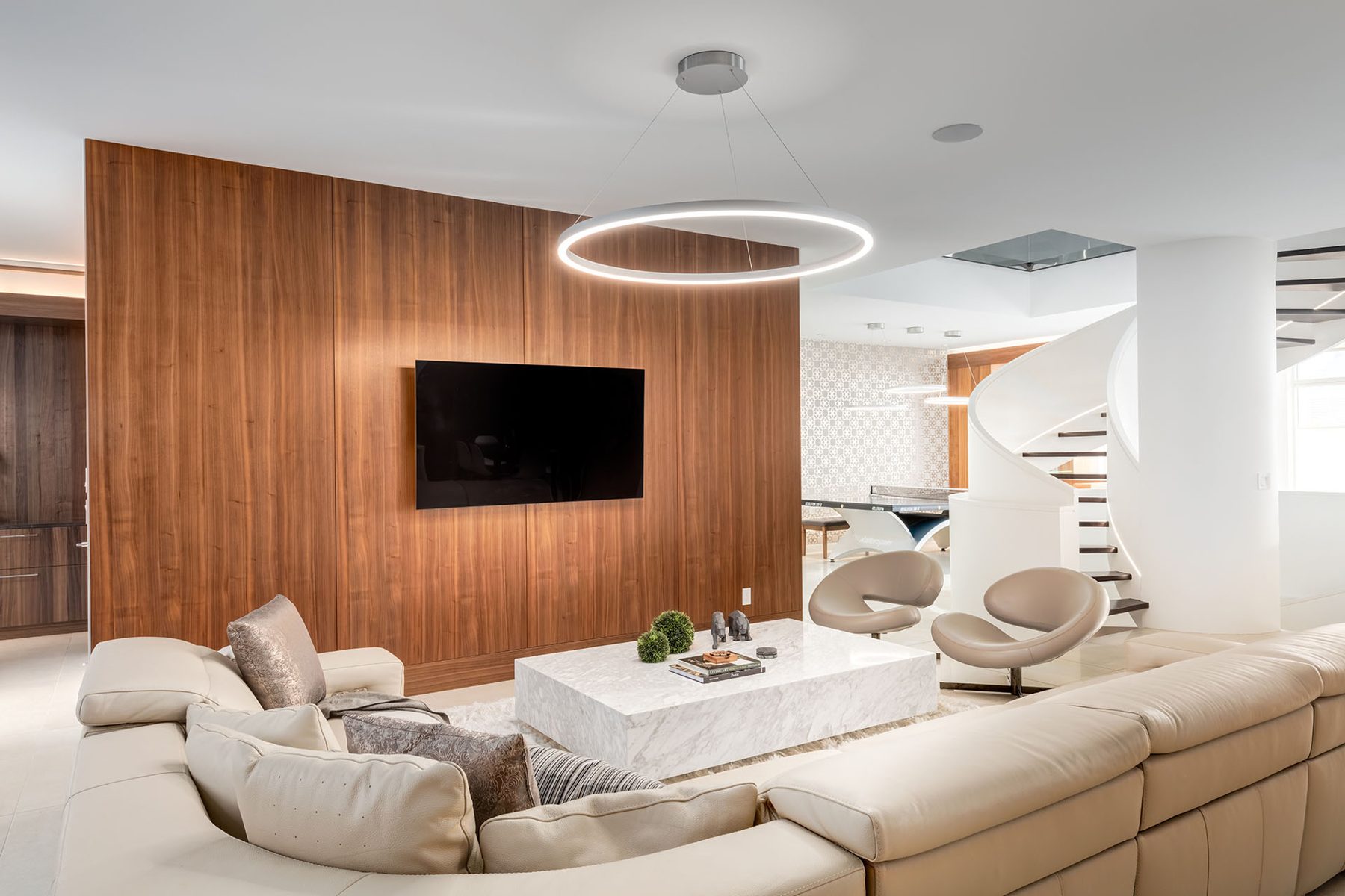 Modern living room with wood paneling, large white sofa, and spiral staircase — Timeless Form