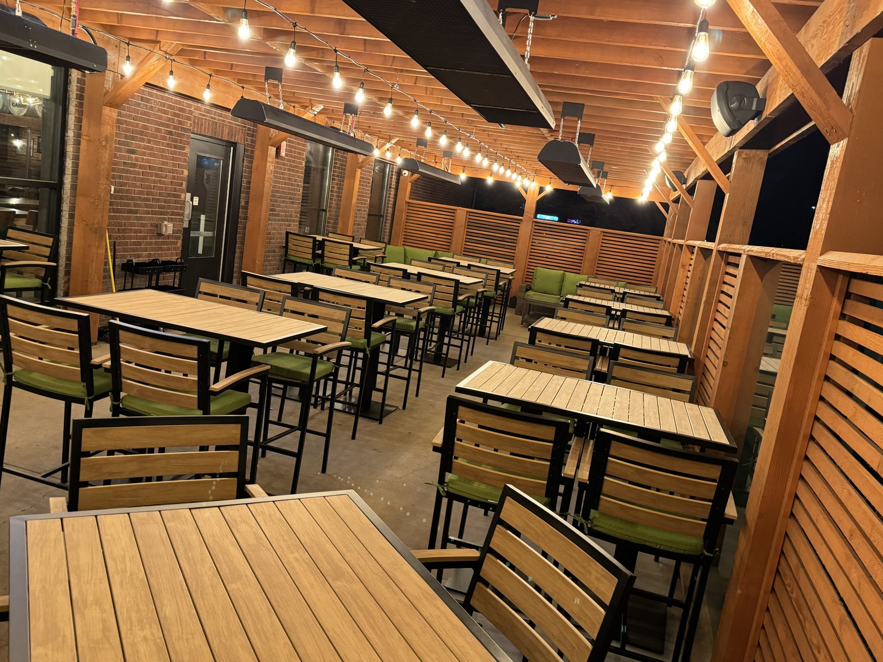 Outdoor patio construction with new tables, chairs, and overhead heaters — Blowers and Grafton (Medicine Hat)