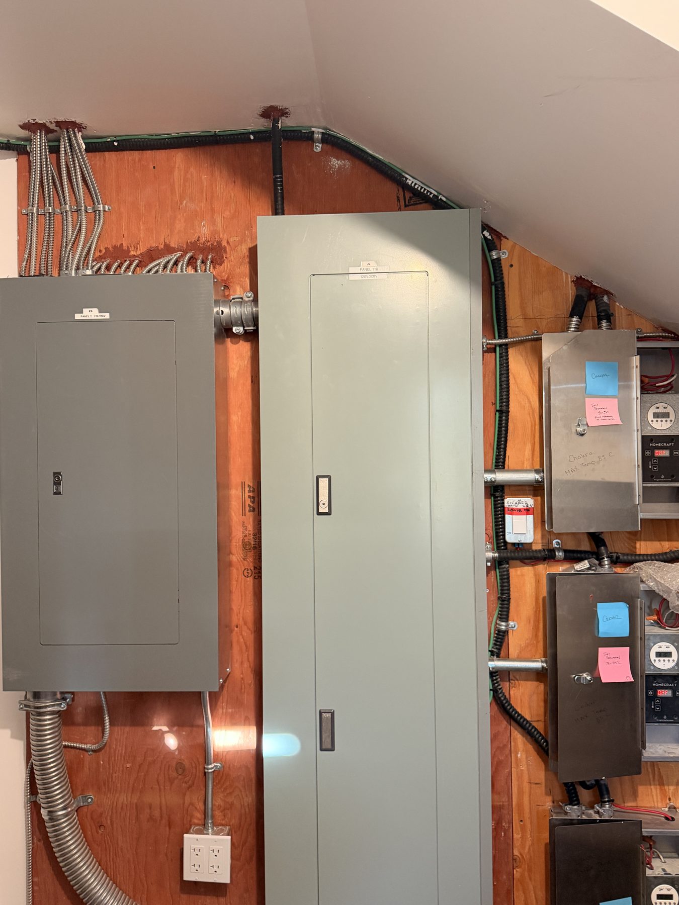 Electrical panels and conduits on wood wall, in-progress installation — Cedar Steam and Spa (Trinity Hills)