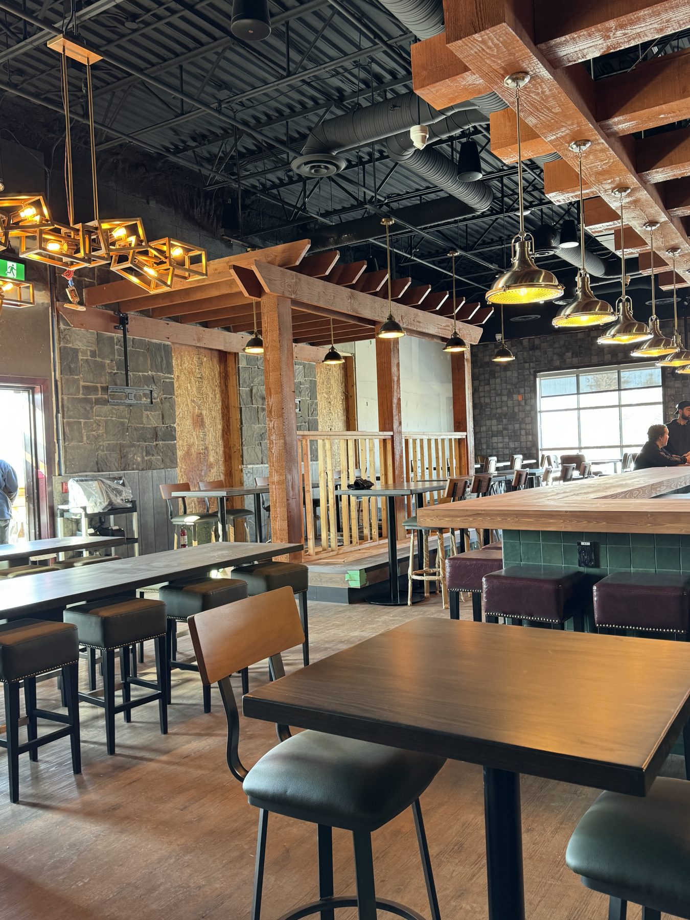 Restaurant interior under renovation with exposed wood beams and ductwork — Blowers and Grafton (Medicine Hat)