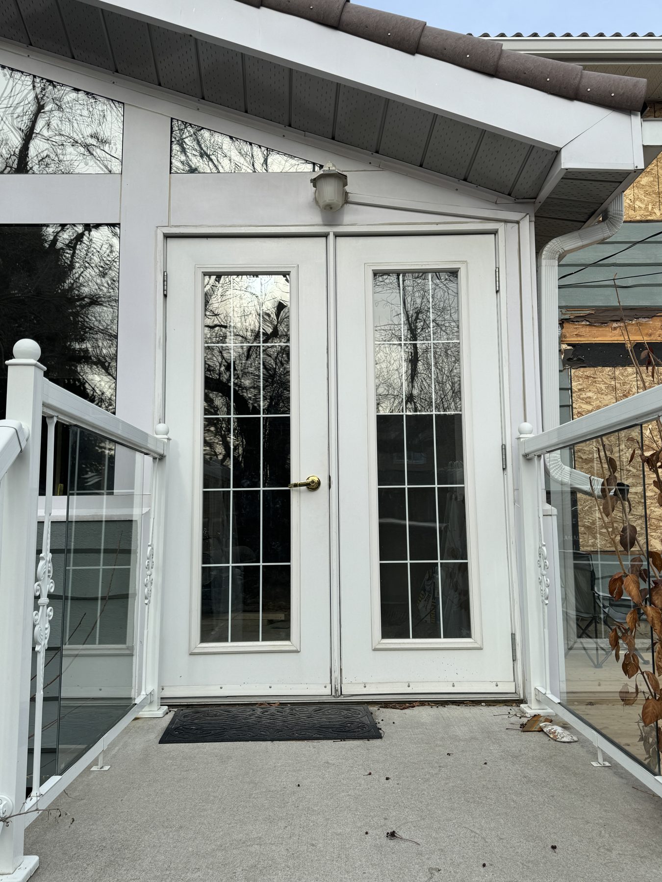 White double doors with glass panes and railing installation — 188 Lake Adams Crescent SE, Calgary