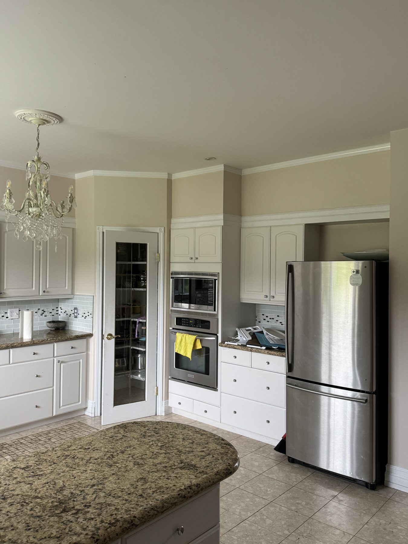 Kitchen with granite island, white cabinets, stainless steel appliances — 14 Lochend Drive, Cochrane