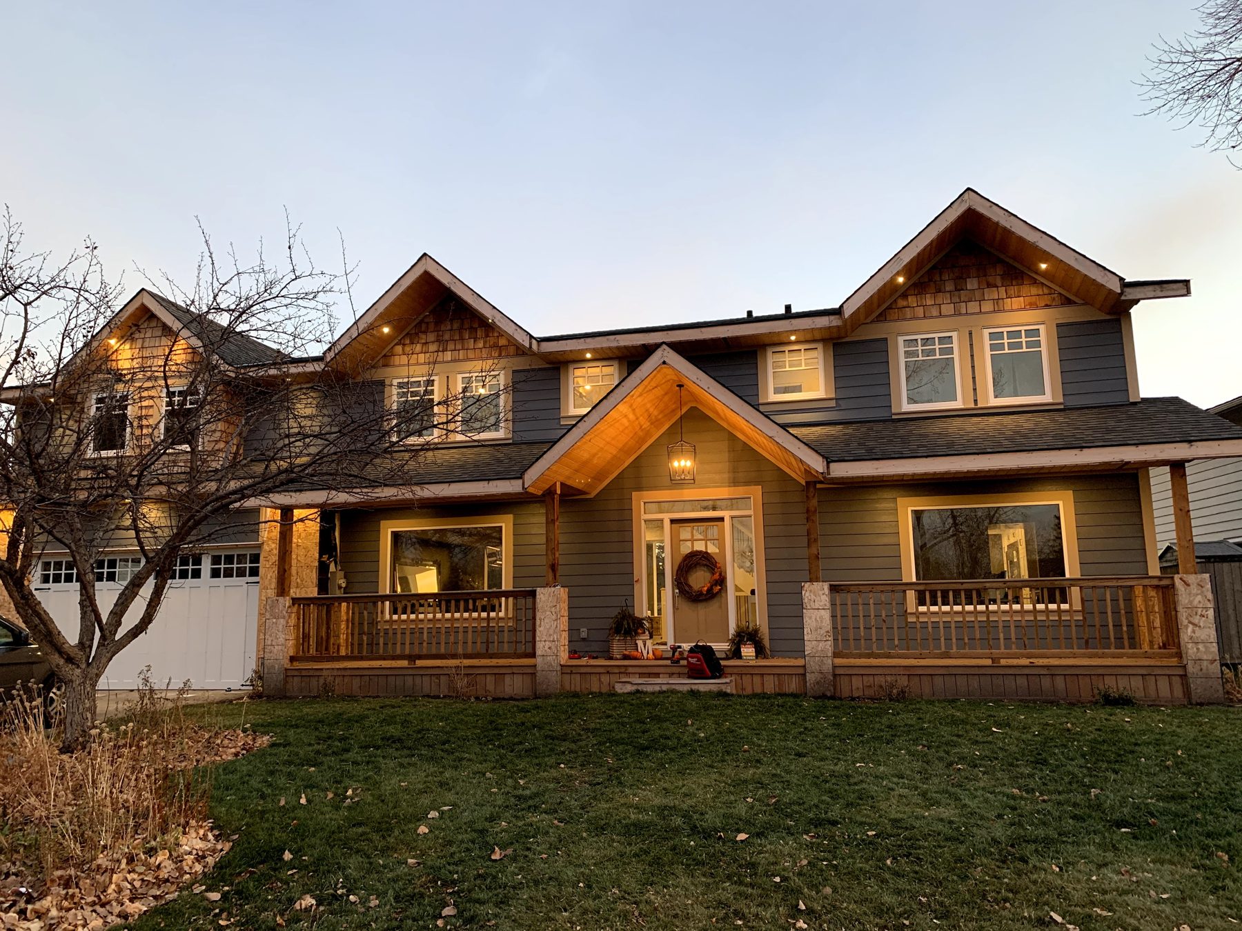 House exterior renovation with new siding, wooden porch, and updated windows — 7 Midlake Green SE, Calgary by Onsite Contracting Services