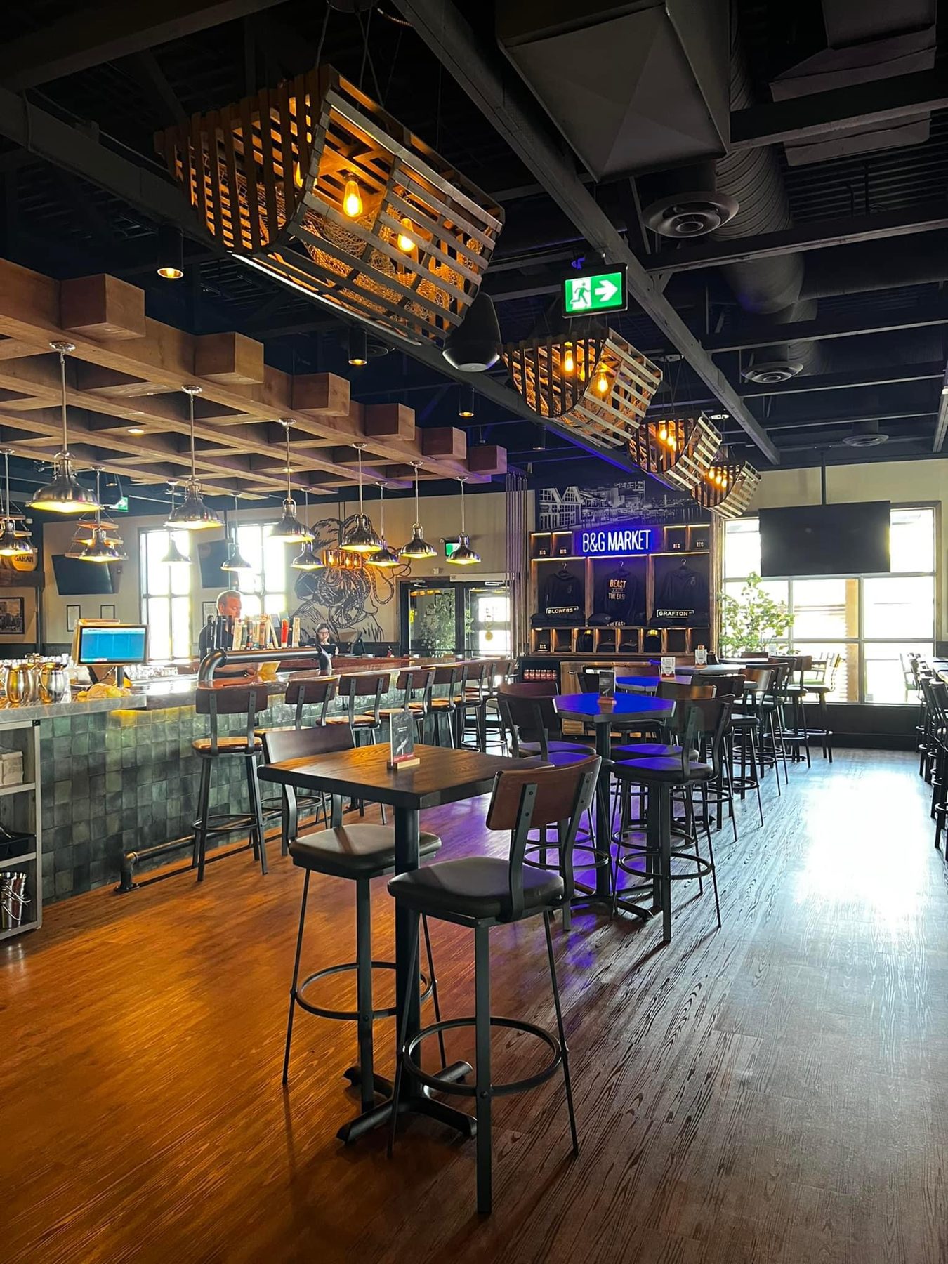 Restaurant interior with bar, tables, chairs, and rustic lighting fixtures — Blowers and Grafton (Lethbridge)