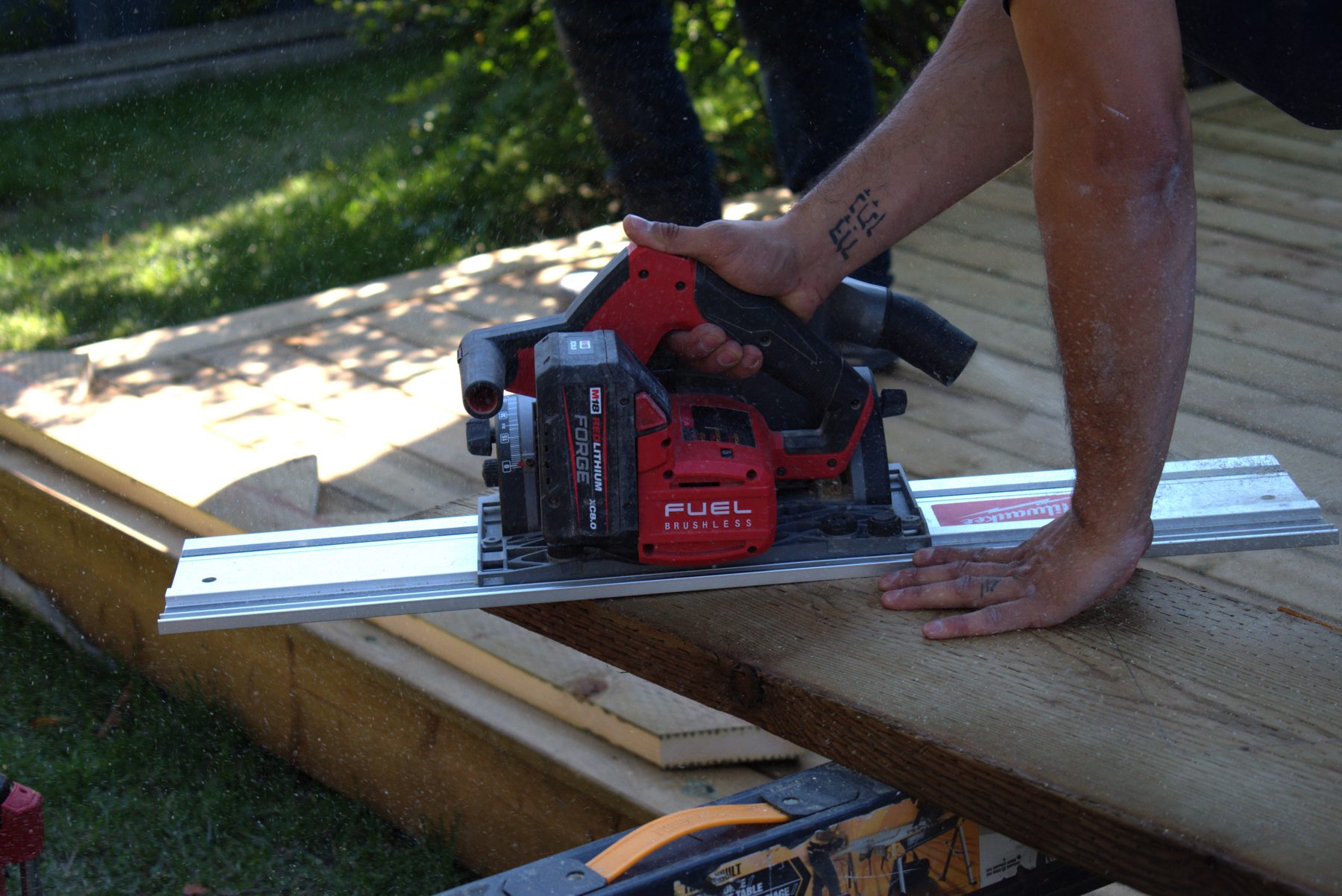 Worker cuts wood planks with a circular saw on a track — 32 Somercrest Manor SW