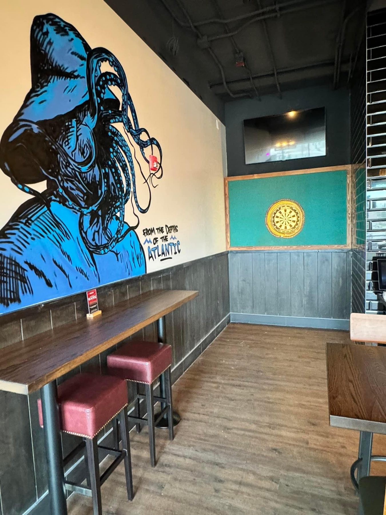 Restaurant interior with octopus mural, bar stools, and dartboard decor — Blowers and Grafton (Shawnessy)
