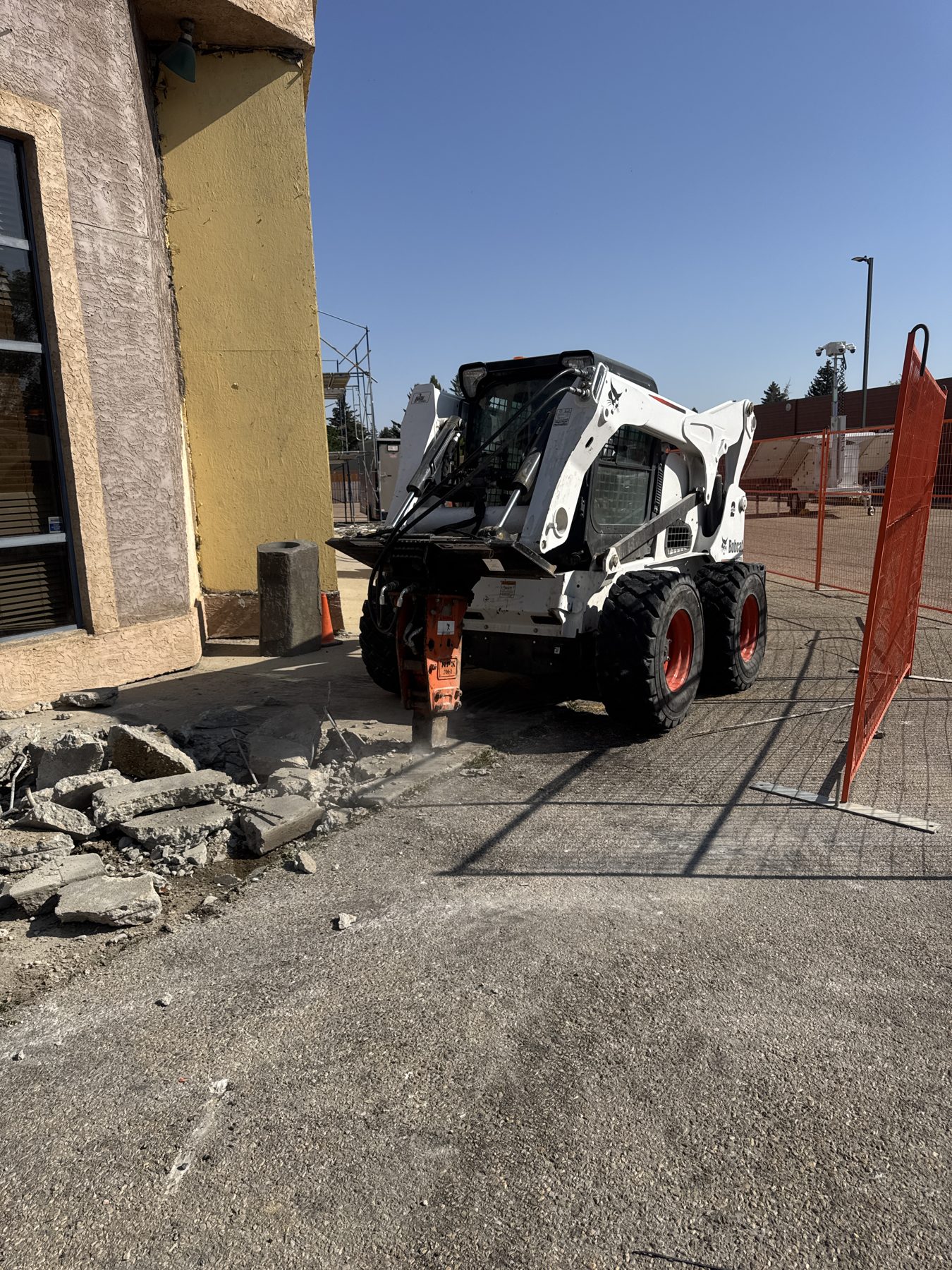 Demolition with skid steer and jackhammer, broken concrete pile — Blowers and Grafton (Red Deer)