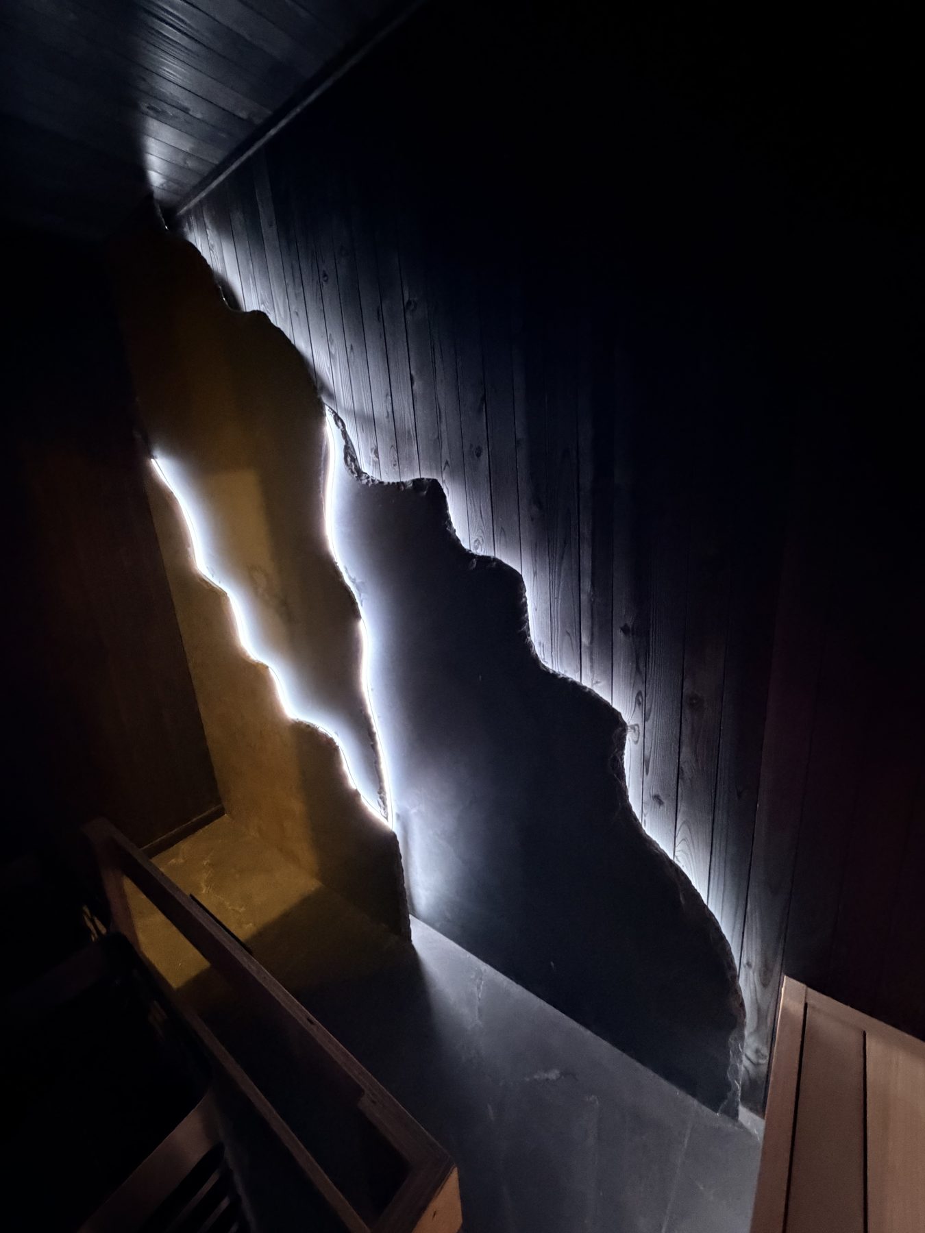 Wooden sauna walls with a jagged stone accent and embedded LED lighting — Cedar Steam and Spa (Trinity Hills)
