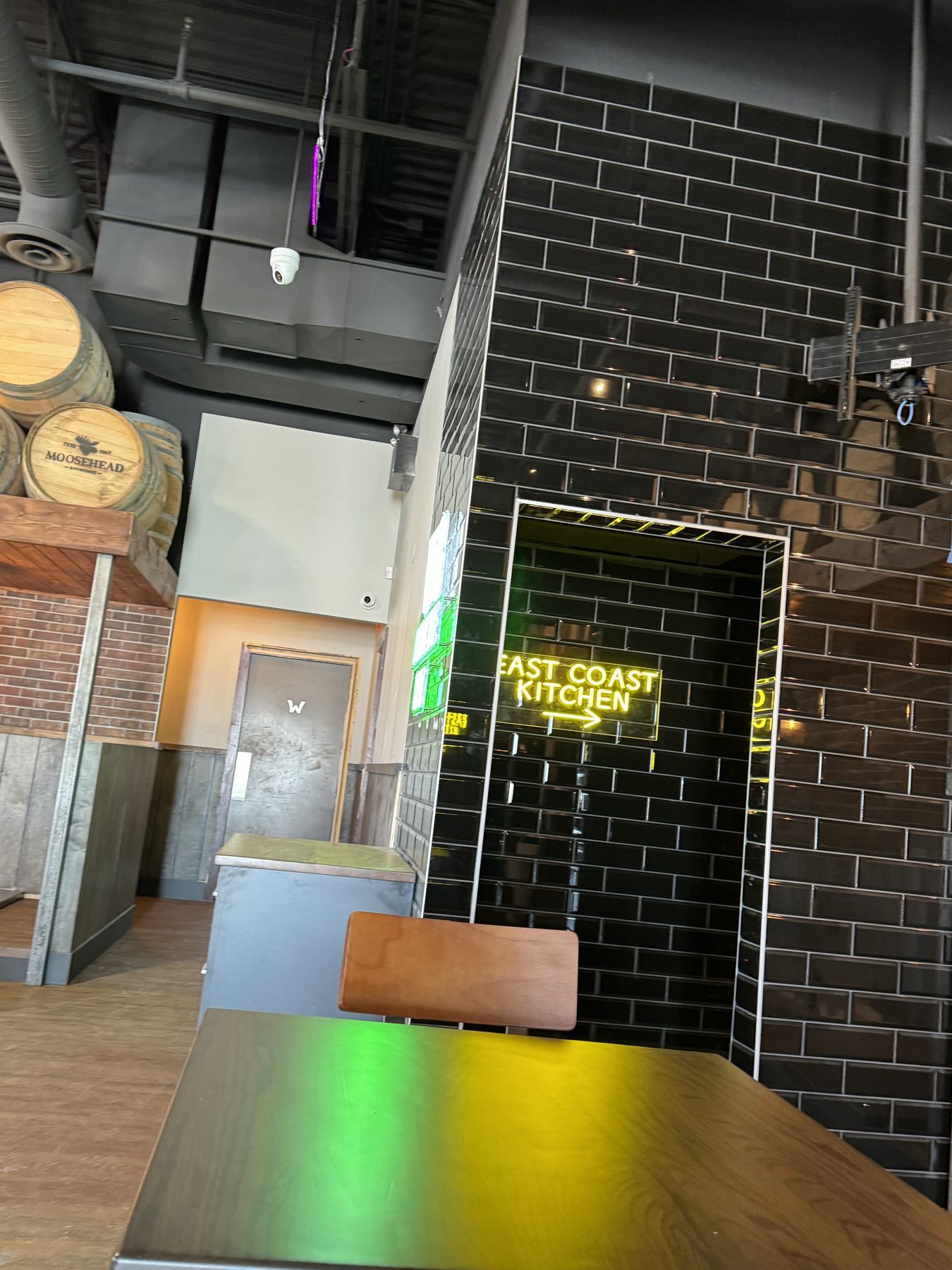 Restaurant interior construction with black subway tile and neon sign — Blowers and Grafton (Medicine Hat)