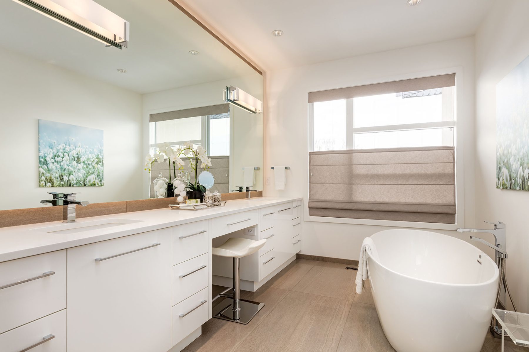 Modern bathroom vanity, soaking tub, artwork, and tile flooring are visible — Casa Blanca