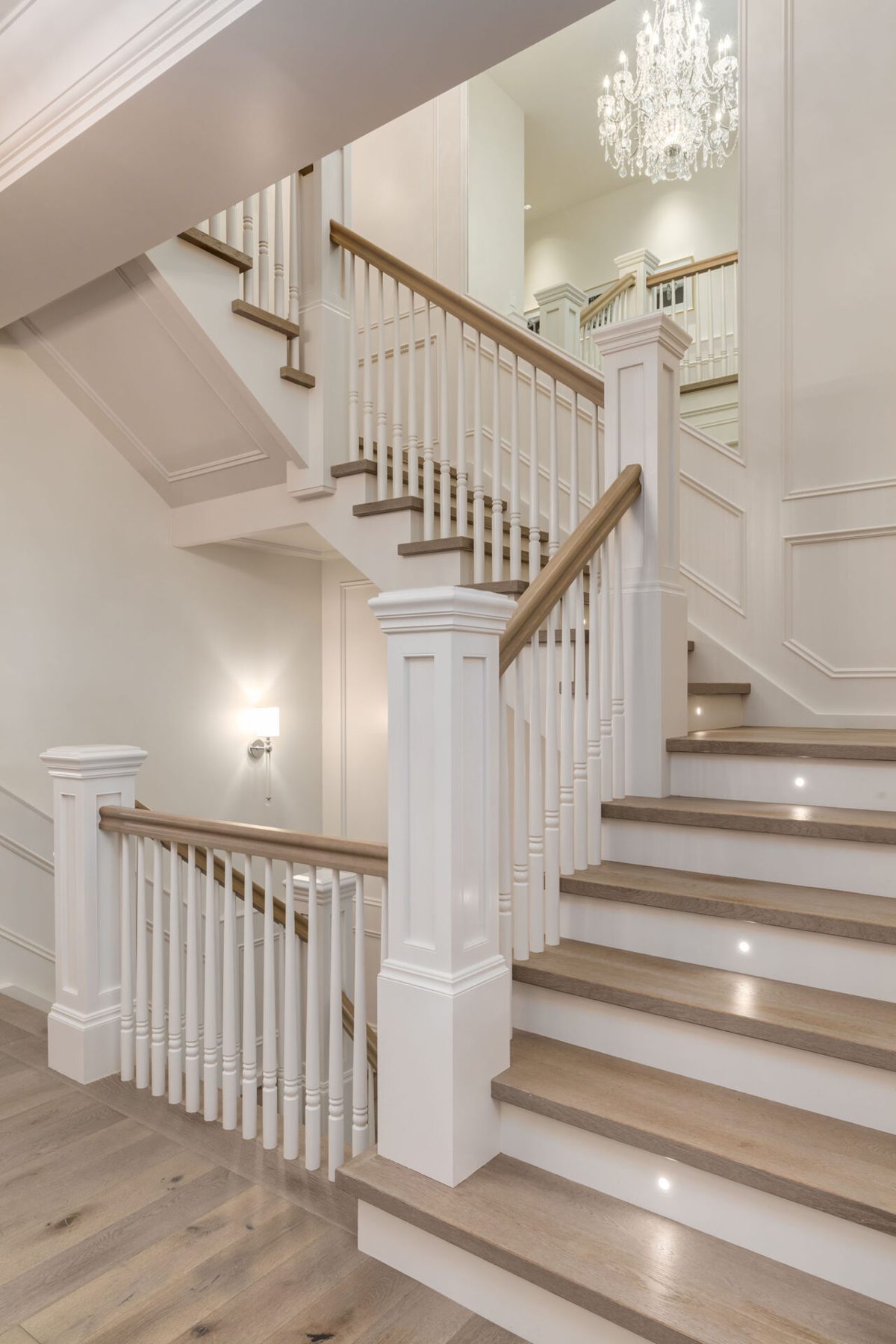 Elegant staircase with white balusters, wooden treads, and cove lighting — White House