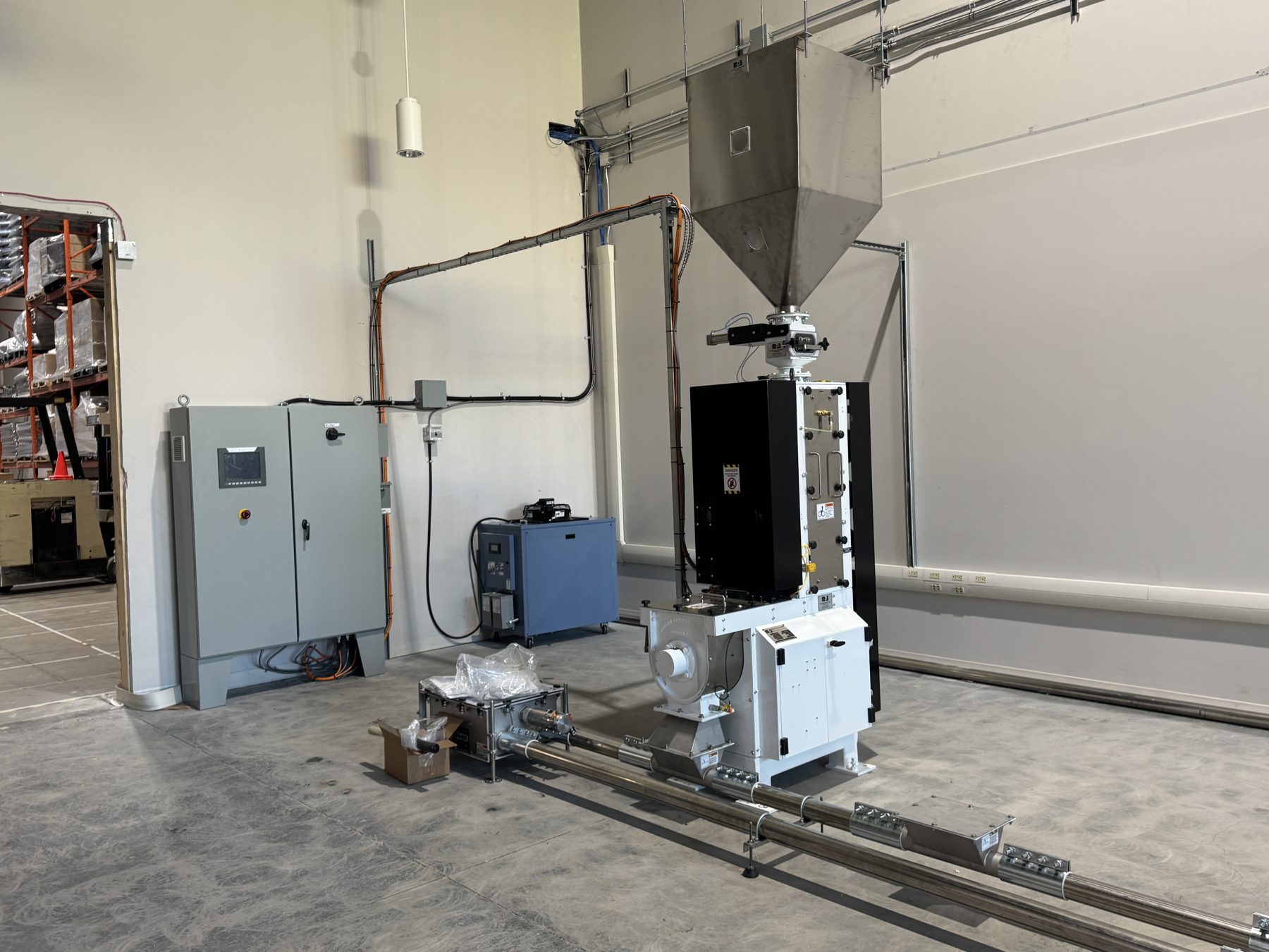 Industrial machine setup with large hopper, control panel, and tubing — Eight Ounce Coffee