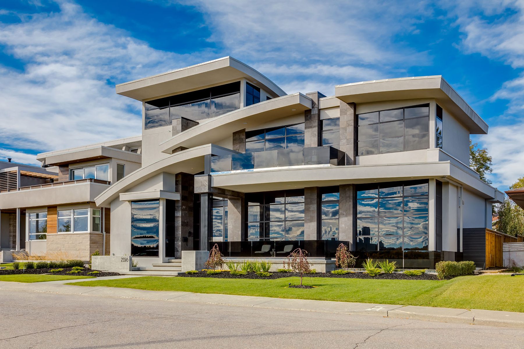 Modern house with stone, stucco, and glass, completed construction stage — Infinity by Onsite Contracting Services