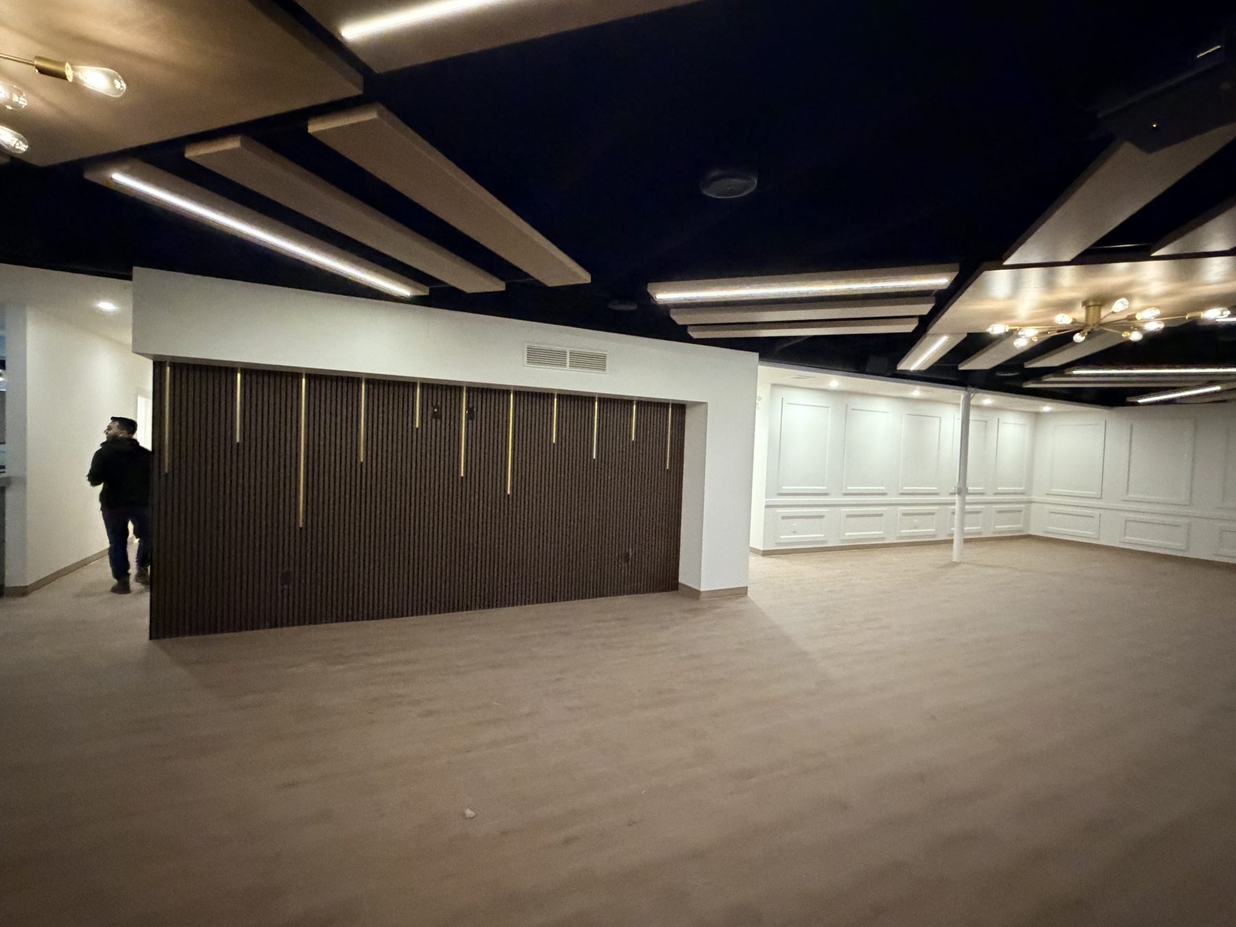 Interior renovation with wood accents, dark ceiling, and wainscoted walls — The Barron Venue