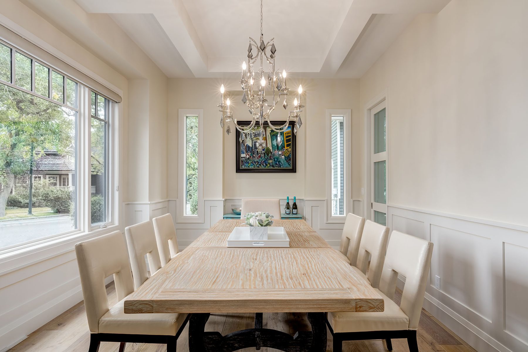 Dining room with coffered ceiling, wainscoting, and modern furniture — Artista