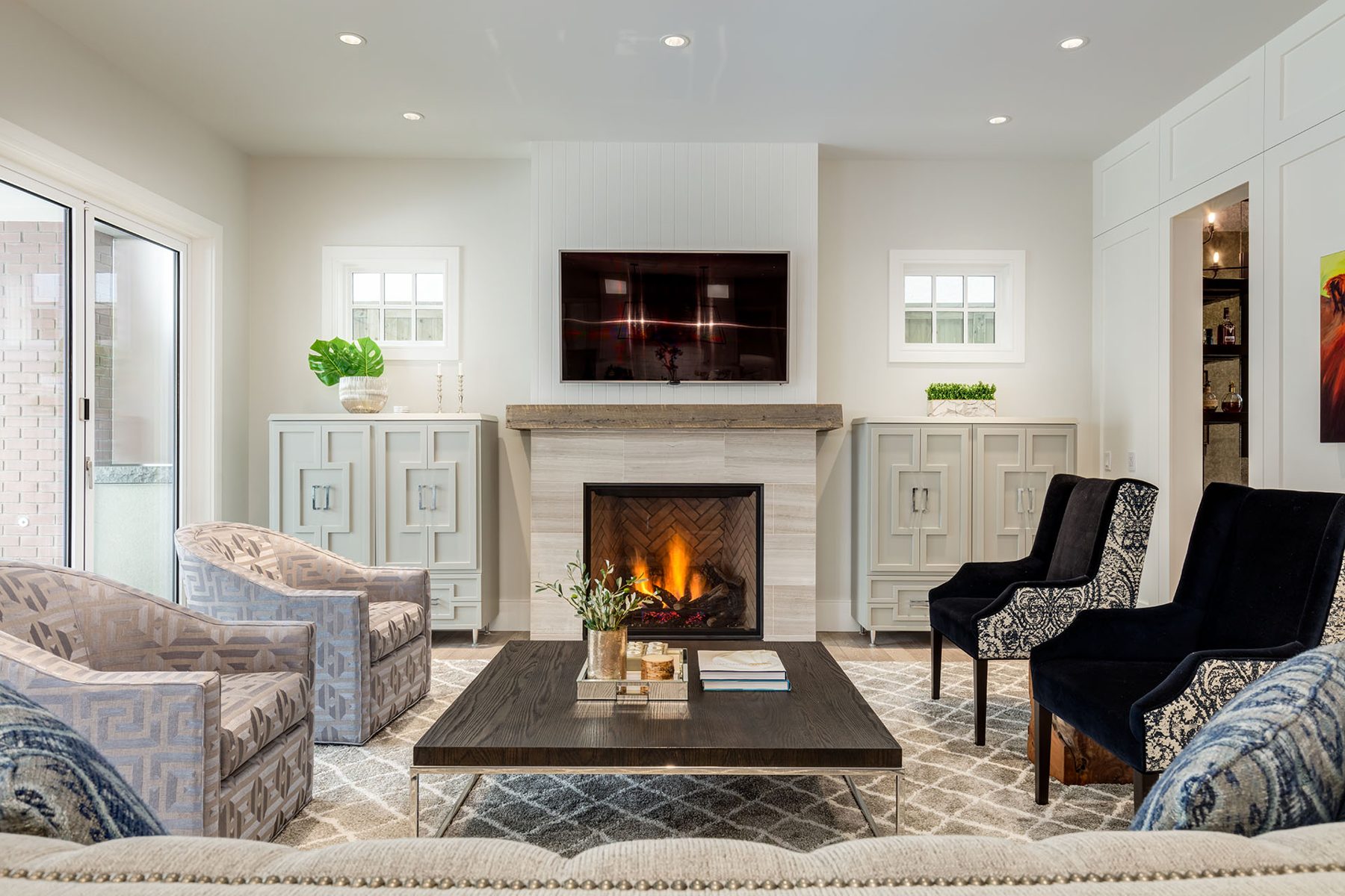 Living room with fireplace, TV, armchairs, and decorative cabinets — Cleret Velour
