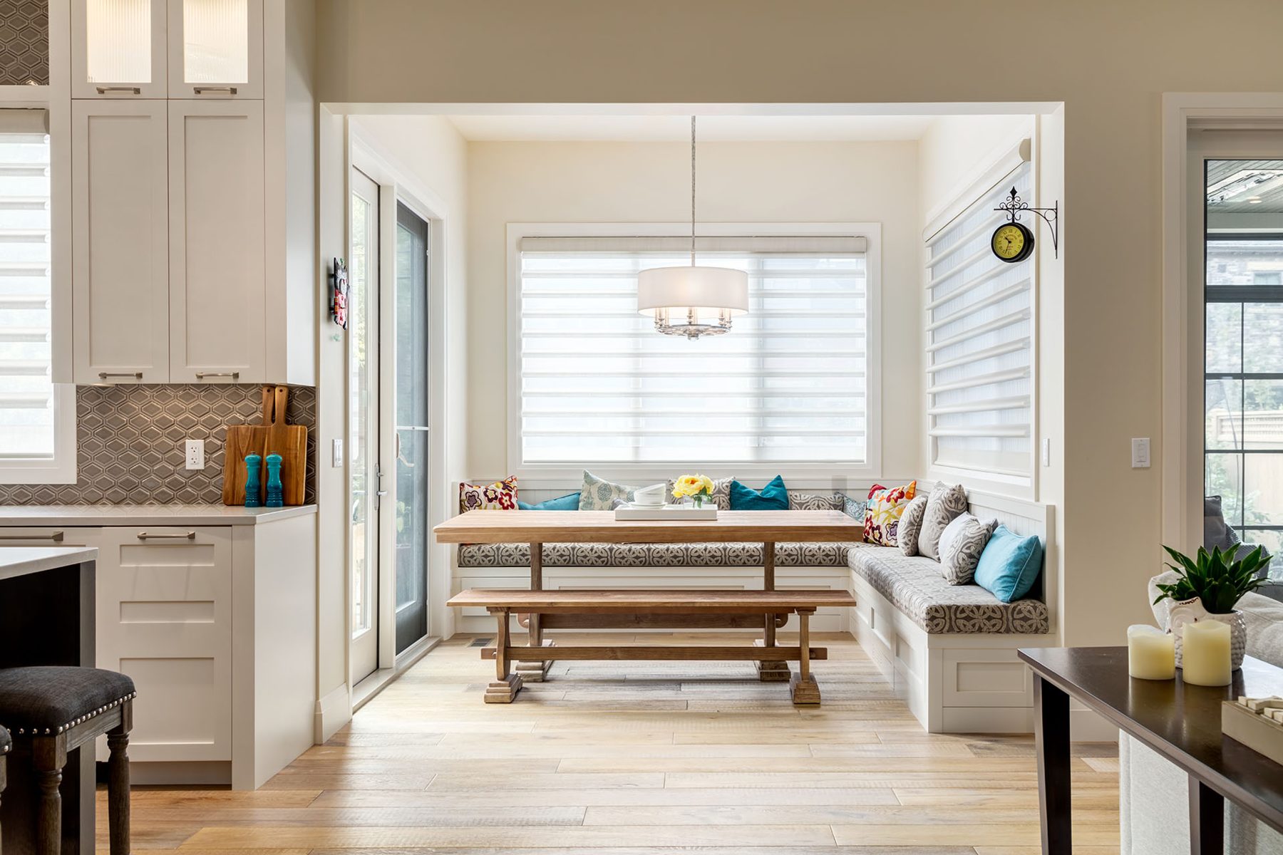 Kitchen banquette seating with table and bench, neutral tones — Artista