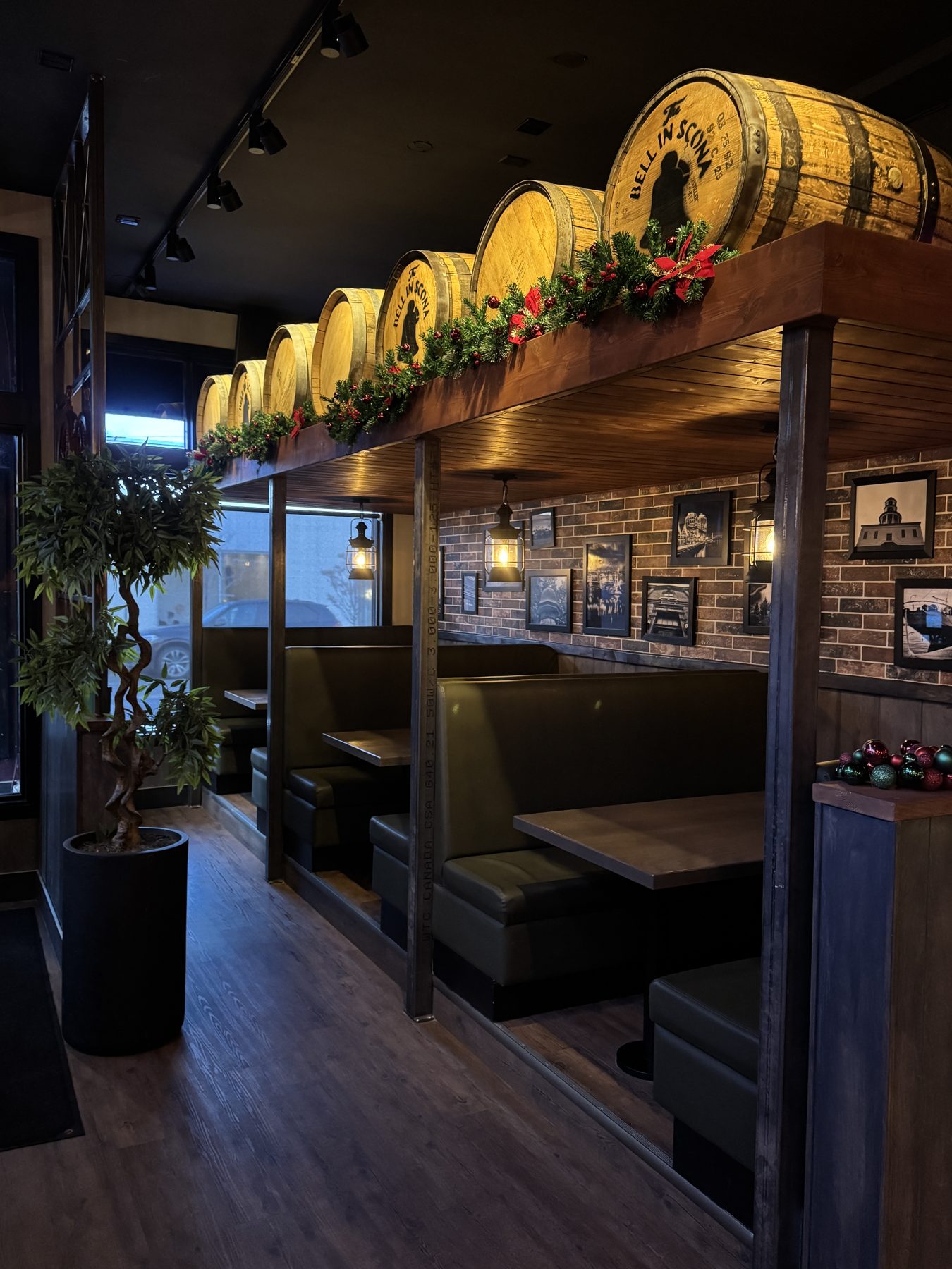 Restaurant booths with wooden barrels, brick walls, and Christmas decor — Blowers and Grafton (Mission) by Onsite Contracting Services