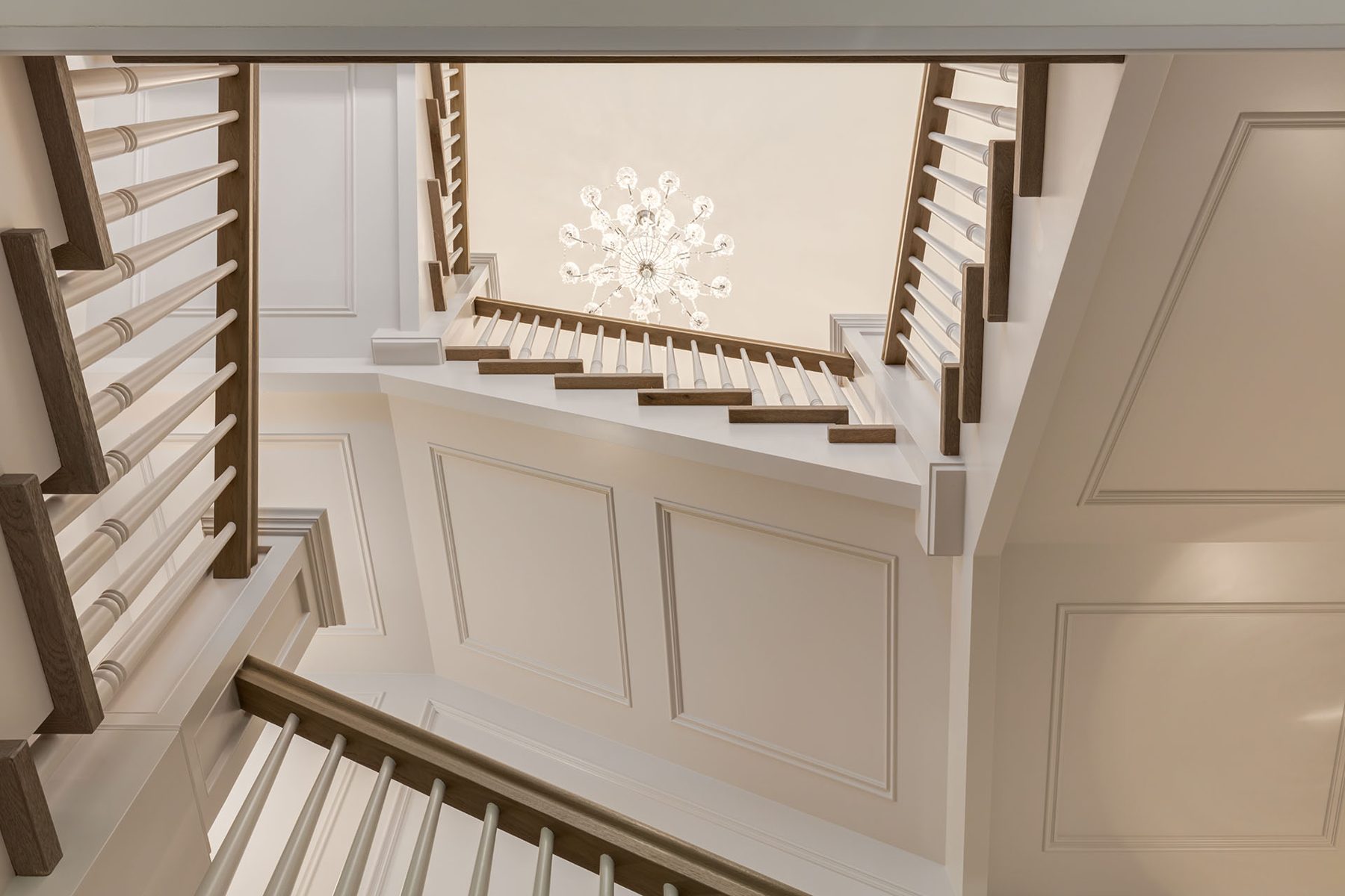 Elegant staircase with crystal chandelier and detailed wall molding — White House